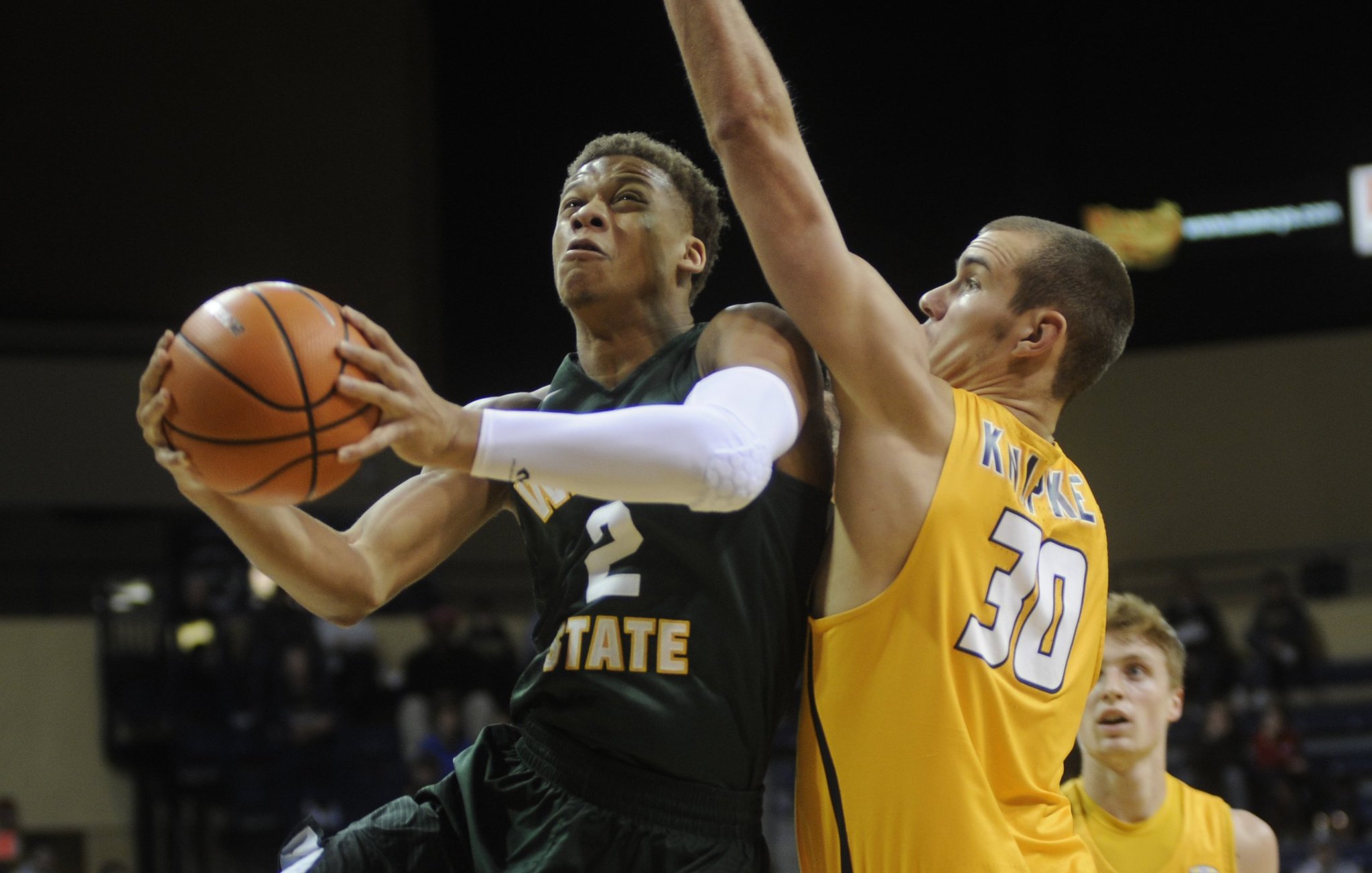 WSU’s Everett Winchester (shooting) is covered by Toledo’s Luke Knapke, a Marion Local High School grad. Wright State defeated host Toledo 77-69 at the Savage Arena in a men’s college basketball game on Sat., Dec. 16, 2017. MARC PENDLETON / STAFF