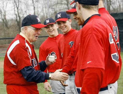 Former North baseball coach Don Henderson shakes hands with the current players after throwing out a ceremonial first pitch to his former player, North assistant Doug Stoll, before North played Northwestern in the Panther Classic Saturday, April 12, 2008.Staff Photo by Barbara J. Perenic