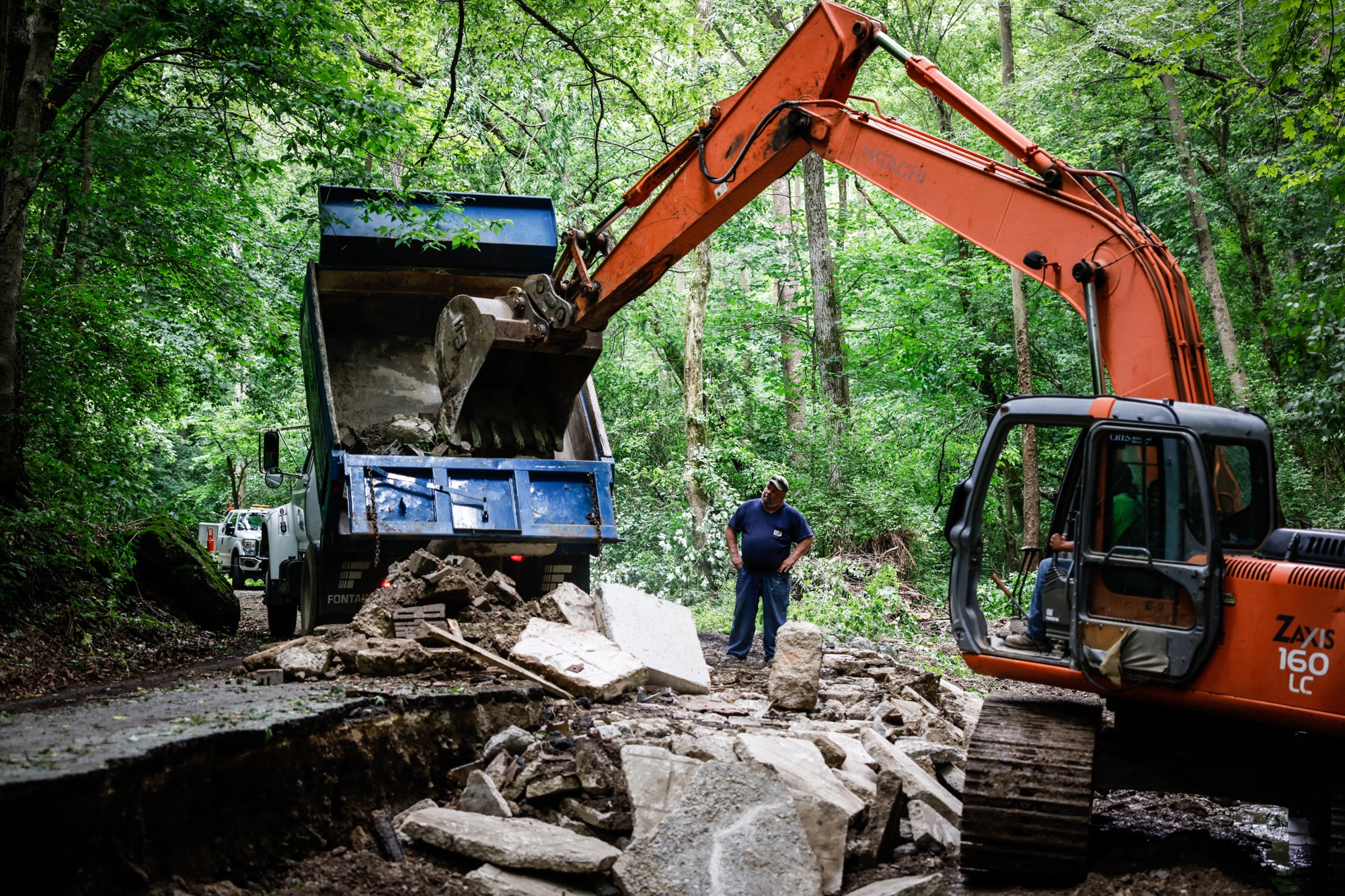 Crew work Monday June 21, 2021 fix Cook Rd. in Spring Valley Twp. after storm on Friday washed out the road. Jim Noelker/Staff