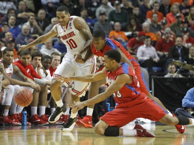 Ohio State’s LaQuinton Ross, left, goes after a loose ball with Dayton’s Kendall Pollard, center, and Vee Sanford in the second round of the NCAA tournament on Thursday, March 20, 2014, at the First Niagara Center in Buffalo, N.Y.