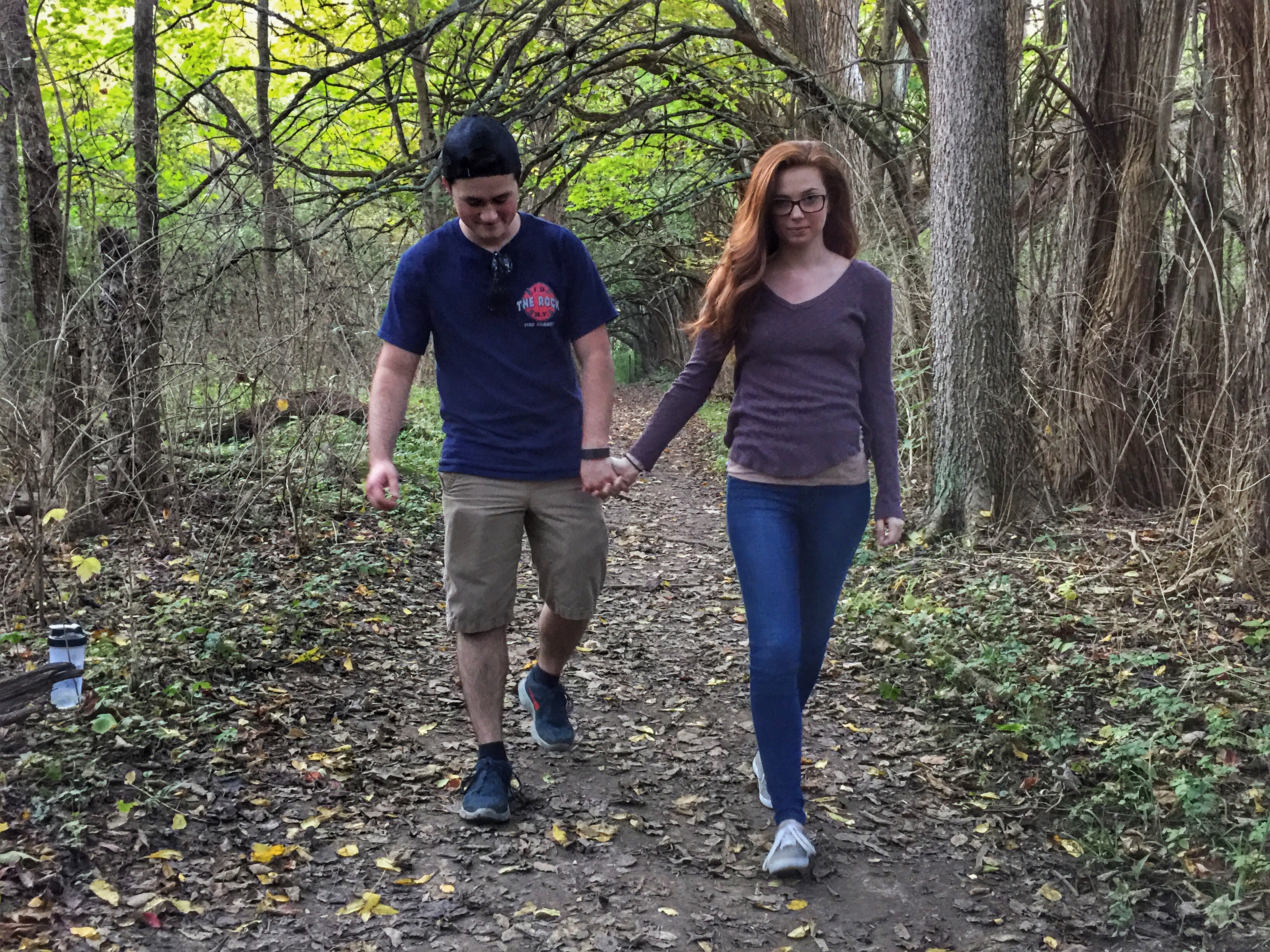 Ryan Williams of Lancaster and Savannah Martin of Bexley enjoy walking through the Osage Orange Tunnel at Sugarcreek MetroPark for the first time.