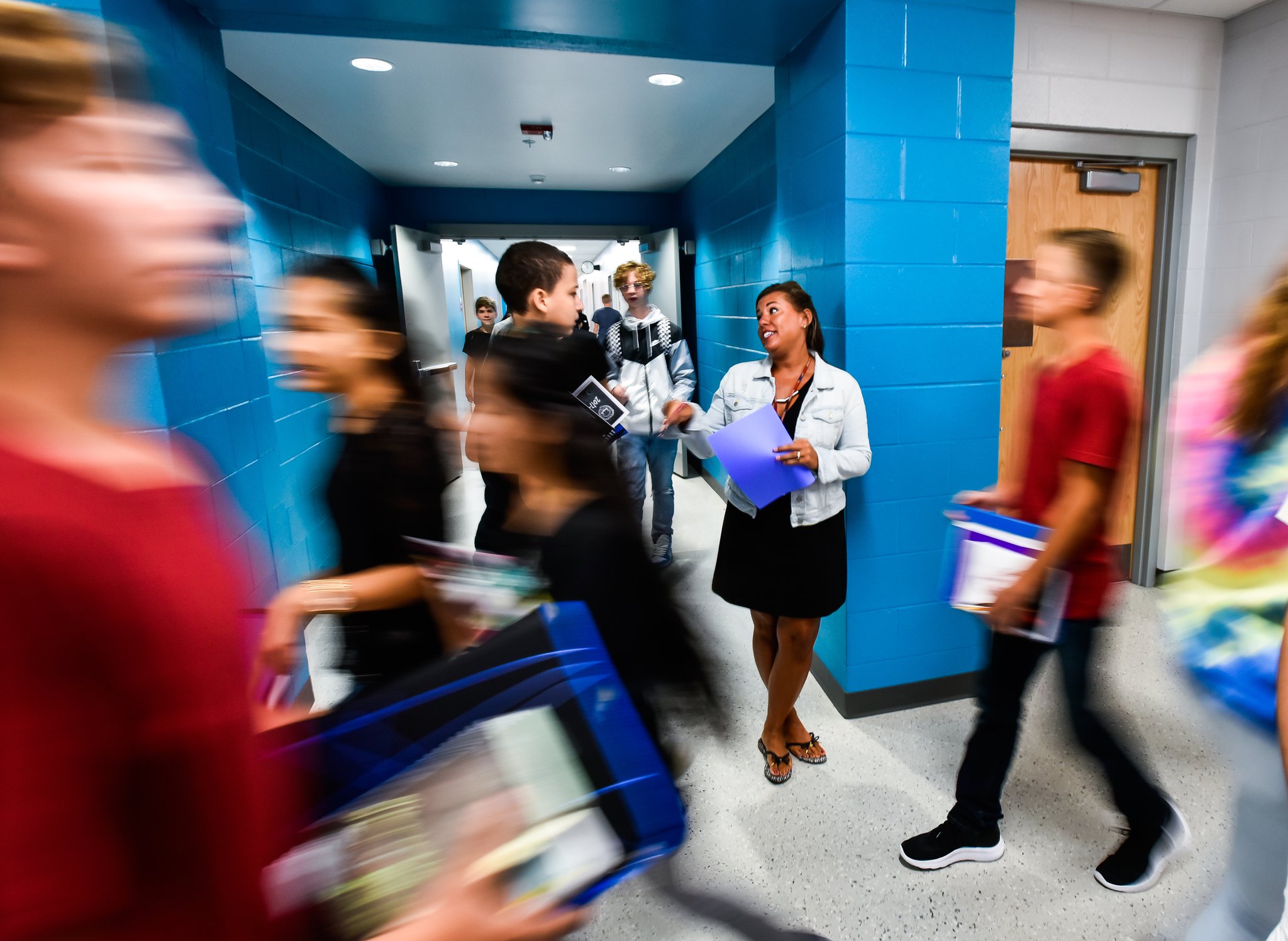 Intervention Specialist Dawn Schneider helps students find their classes in the hallway on the first day of classes at the new Fairfield Freshman School on Tuesday, Sept. 5, in Fairfield.
