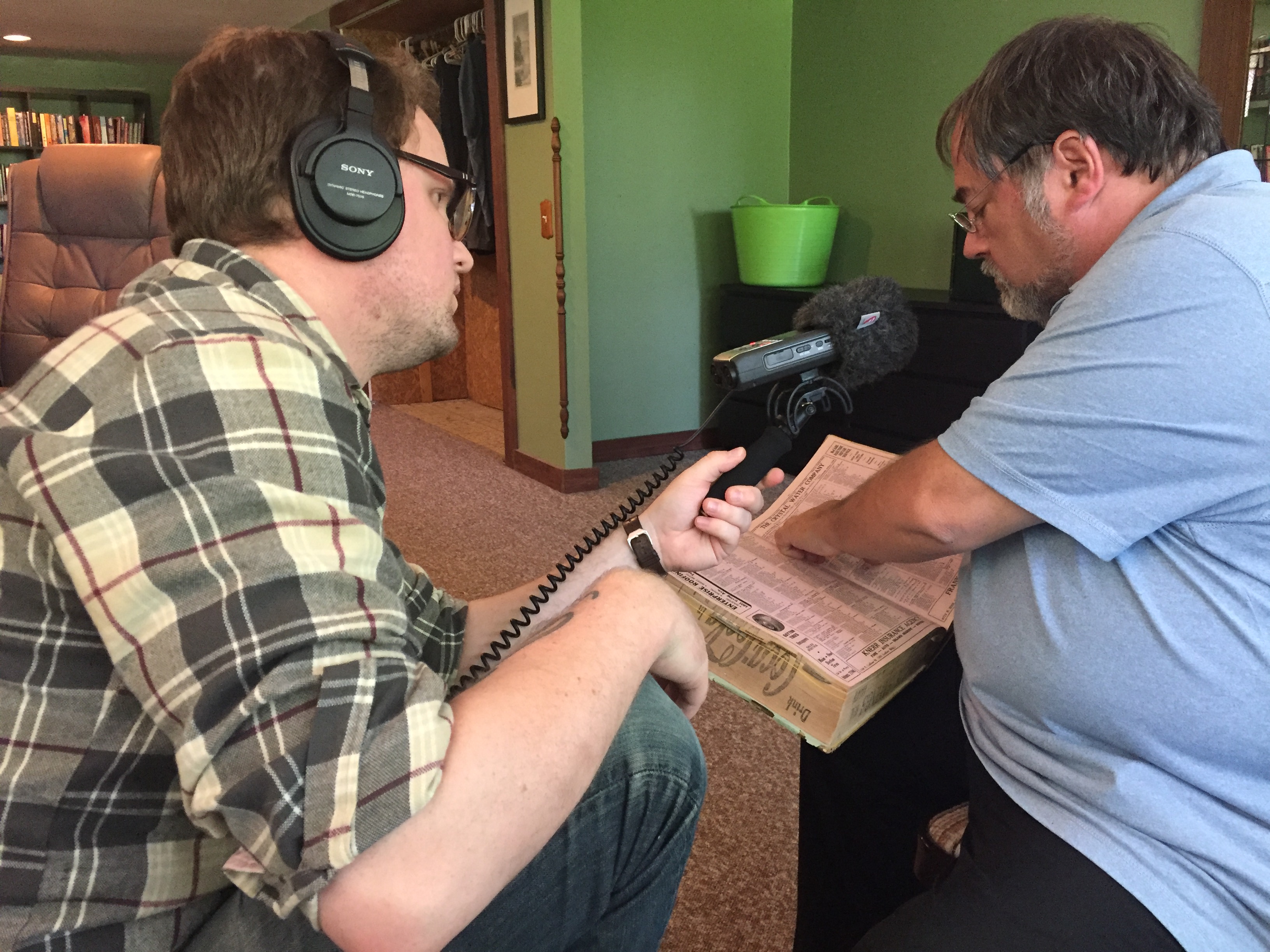 On and off over two year, George Drake Jr. lead a team that includes his wife, Ruth Reveal, and a farmer named Jessi Sievers on a quest to piece together the real-life story behind a letter found under an Oakwood bathtub. The result if the podcast Fifth and Ludlow. Drake Jr is pictured recording Dayton Historian Curt Dalton as he looks through a city directory .