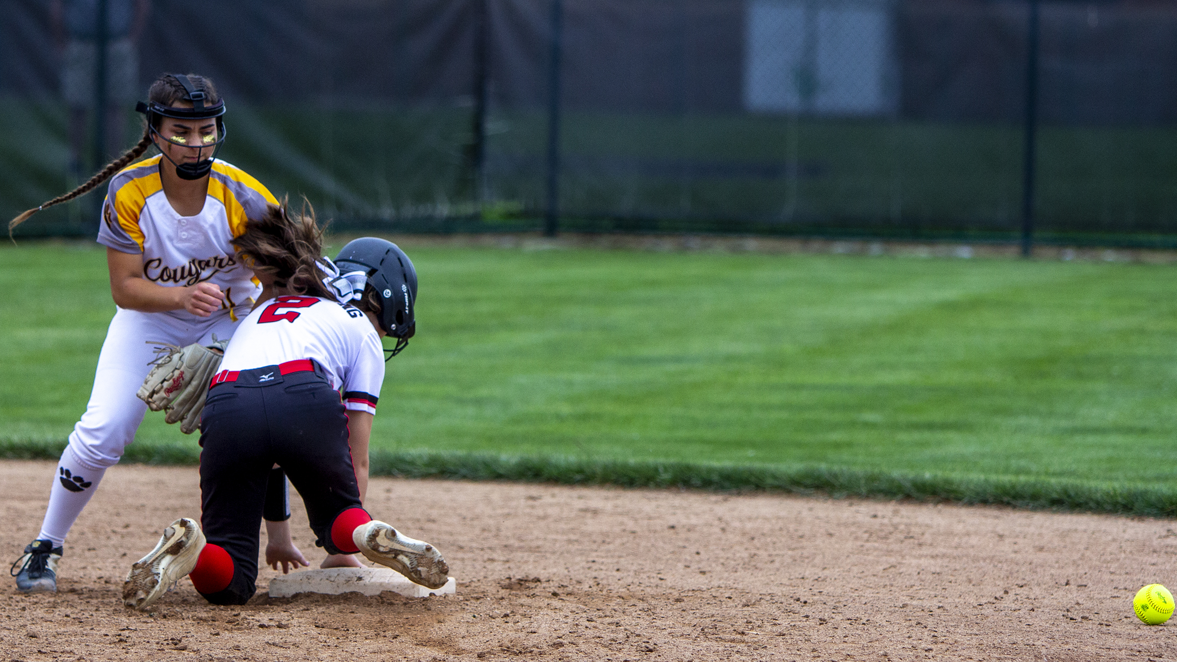 The ball gets past Kenton Ridge second baseman Jacee Hamilton on a throwing error during the sixth inning Saturday in the Division II region final at Mason. The baserunner was tagged out by Hamilton in a rundown between second and third base, but an obstruction ruling allowed the runner to return to second base. Photo by Jeff Gilbert