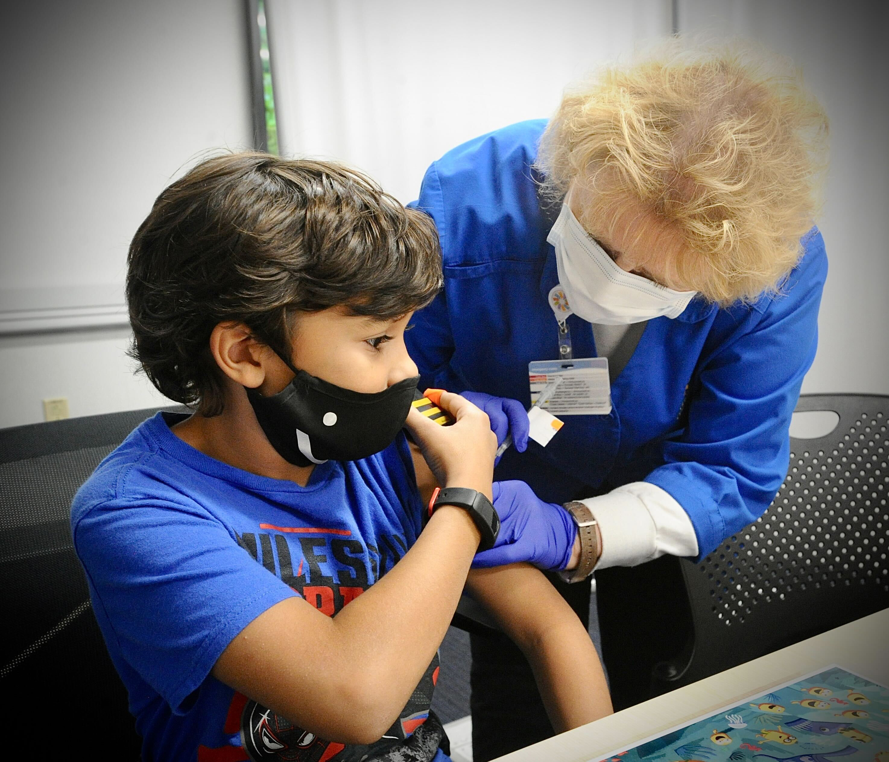 Roman Collier, age 10, receives his COVID-19 vaccine at Dayton Children's Monday, Nov. 8, 2021. MARSHALL GORBY\STAFF