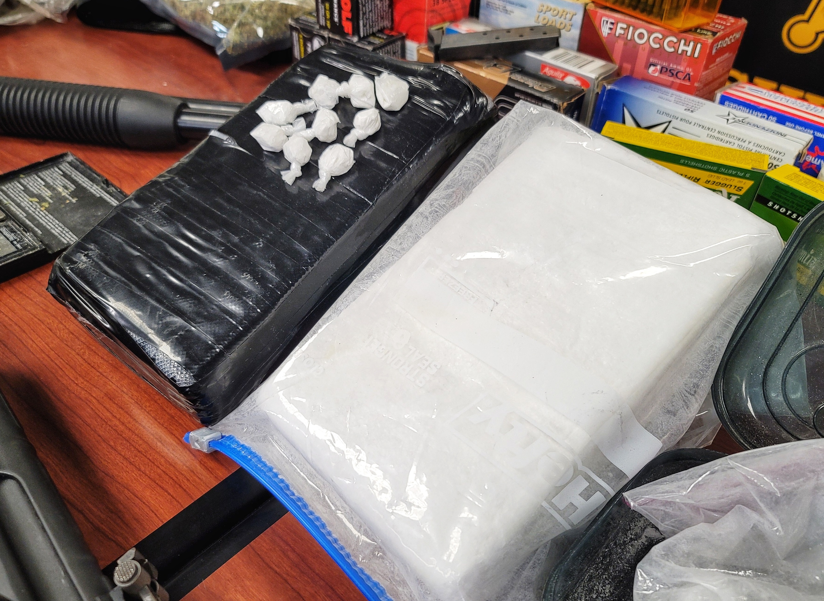20 pounds of marijuana, two kilos of cocaine, guns and $75,000 in cash were seized from a Ridgelawn Avenue house in Hamilton Wednesday buy the Butler County B.U.R.N. unit. NICK GRAHAM/STAFF