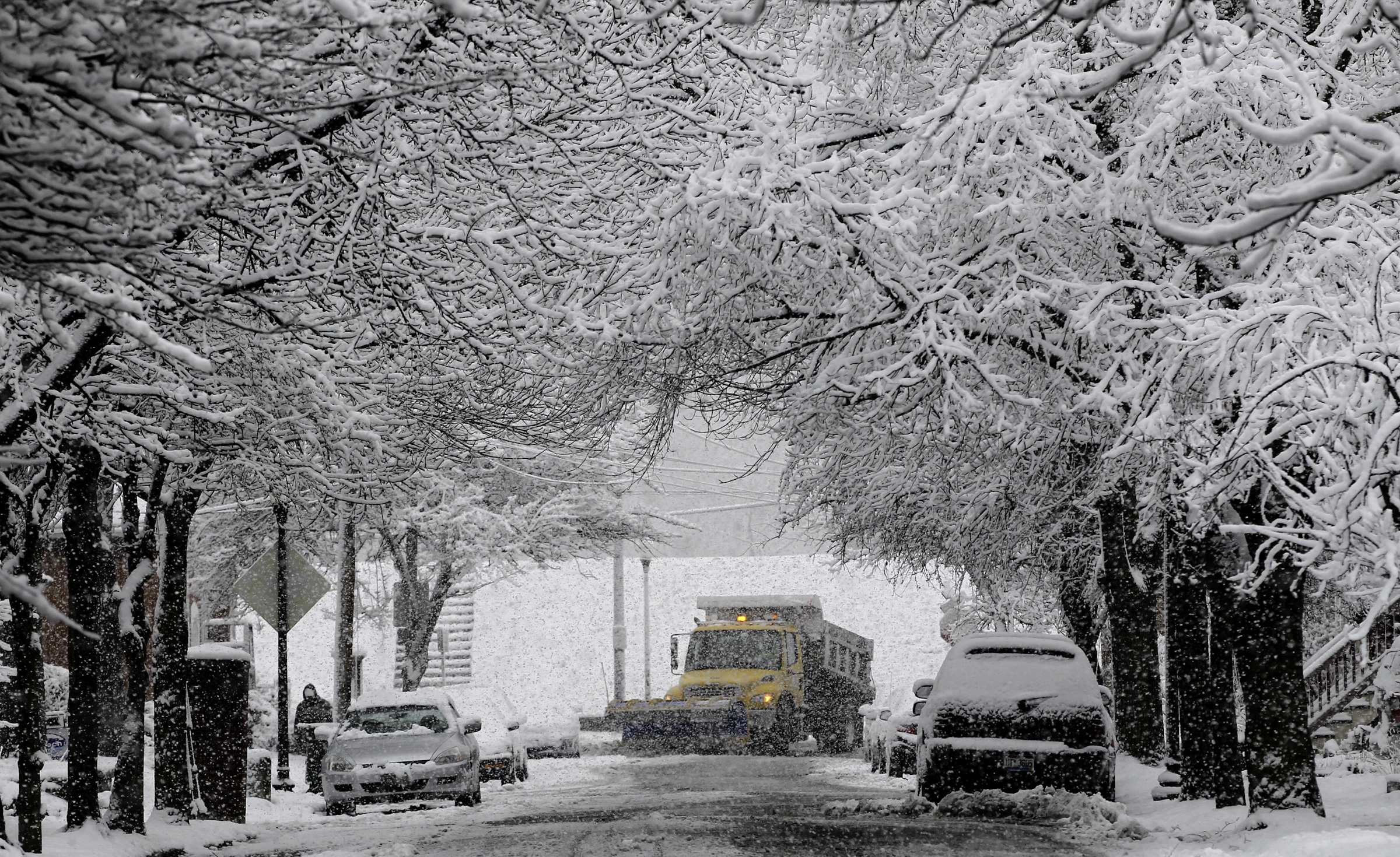 A Dayton snow plow driver works the area around Riverview Avenue and McDaniel Street early Monday, March 25, 2013, cleaning up after an early spring snow. The official snowfall total in Dayton on Sunday was 5.8 inches, as measured at the Dayton International Airport. That breaks the daily record for March 24 which was previously 4 inches set in 1912. CHRIS STEWART / STAFF
