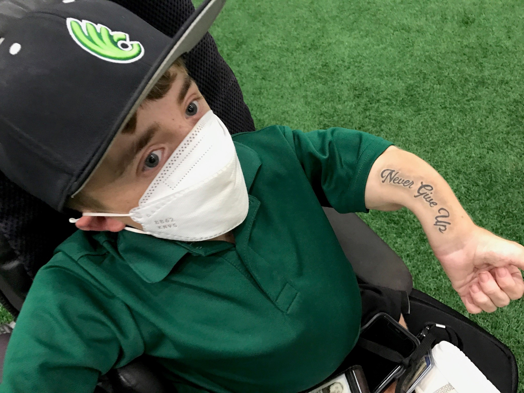 Daniel “Danny” McCarty, the Wilmington College assistant baseball coach who is the Fightin’ Quakers recruiting coordinator and director of baseball operations, shows the “Never Give Up” tattoo he got inked on his left arm this summer. McCarty suffers from an inherited genetic bone disorder -- osteogenesis imperfecta – and has had over 300 broken bones in his 18 years of life. (Photo by Tom Archdeacon)