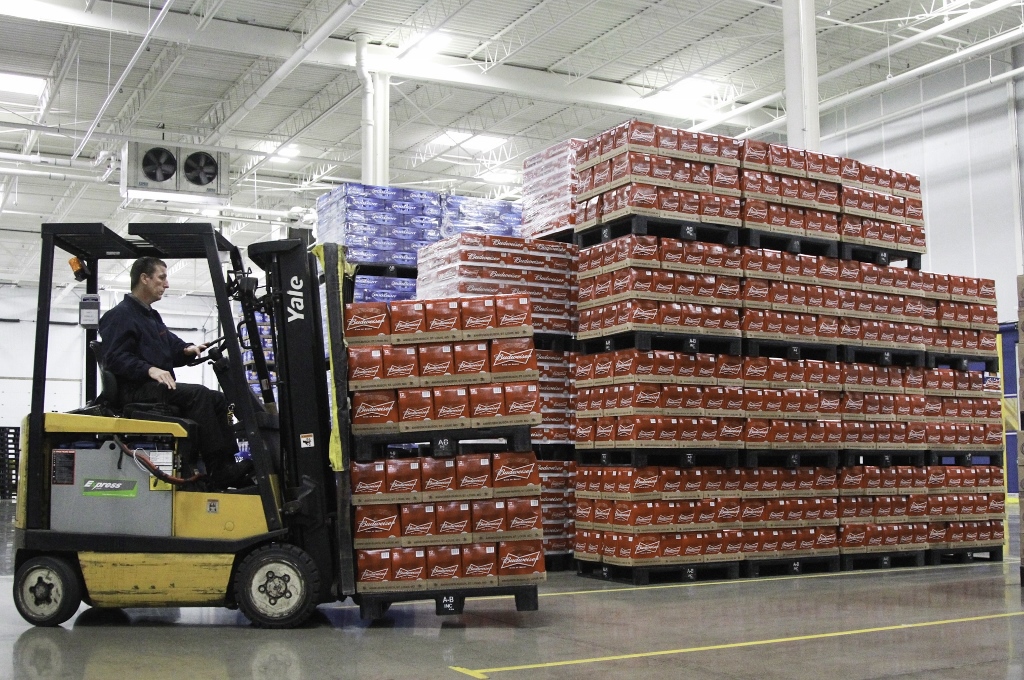 A warehouse operations worker at Heidelberg Distributing moves pallets of beer in July 2013 inside the company’s then-new distribution center in the former Cooper Tire building in Moraine. FILE PHOTO BY CHRIS STEWART / STAFF