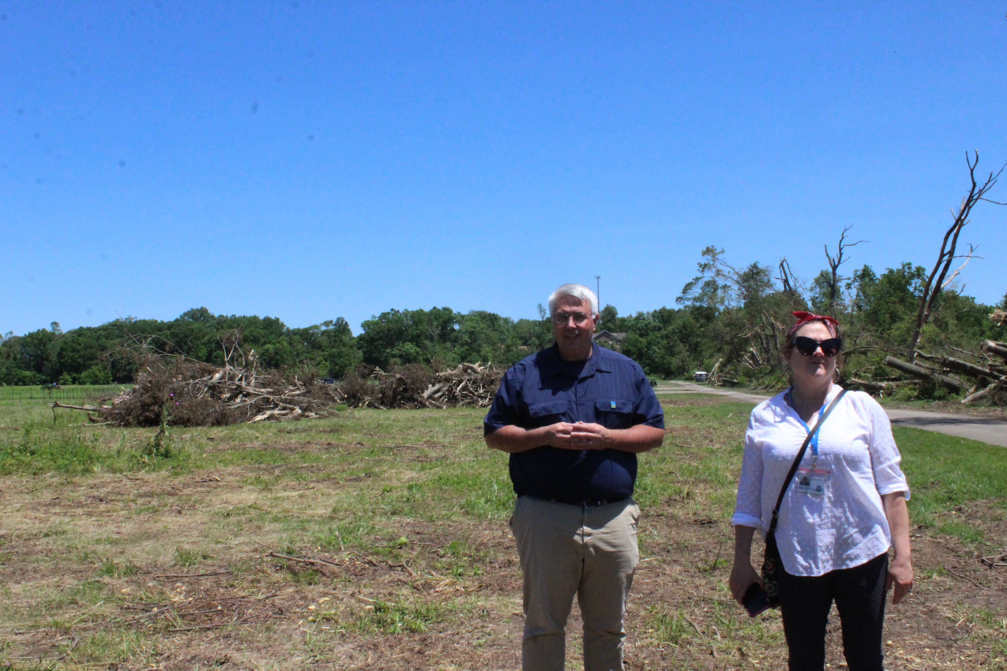 Chris Pion, Five Rivers MetroPark’s director of parks and conservation, and Kristen Wicker, the park system's marketing manager, look at tree damage near Wegerzyn MetroPark's community garden plots.