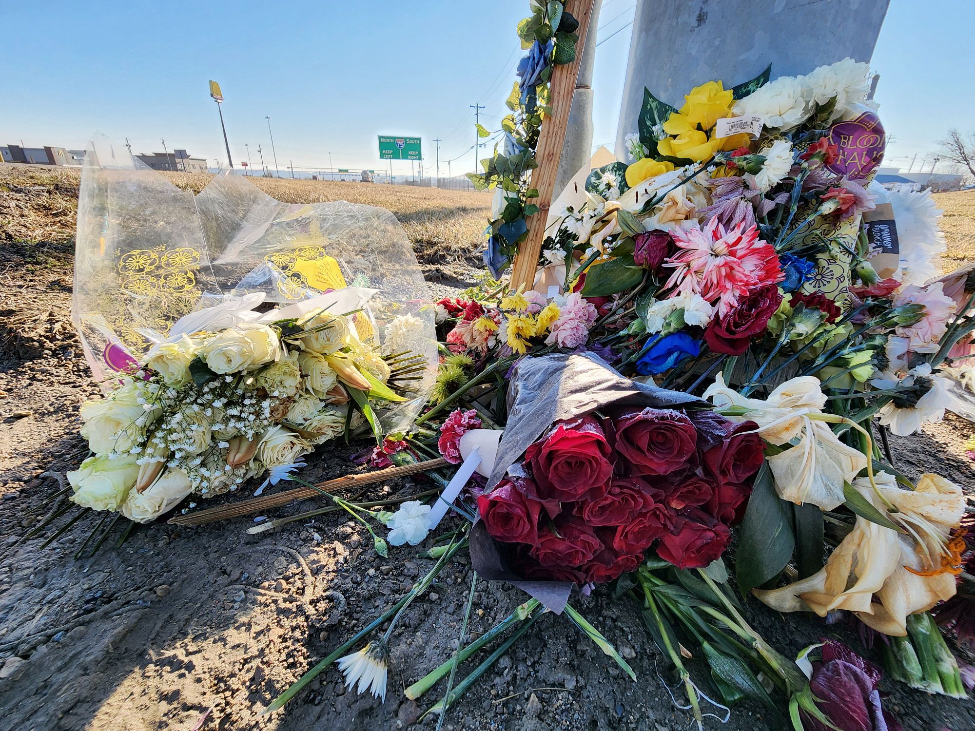 Flowers lay at the site where Dustin Booth died after he was shot during an incident with Monroe police, which took pace near Garver Road and Ohio 63. NICK GRAHAM / STAFF