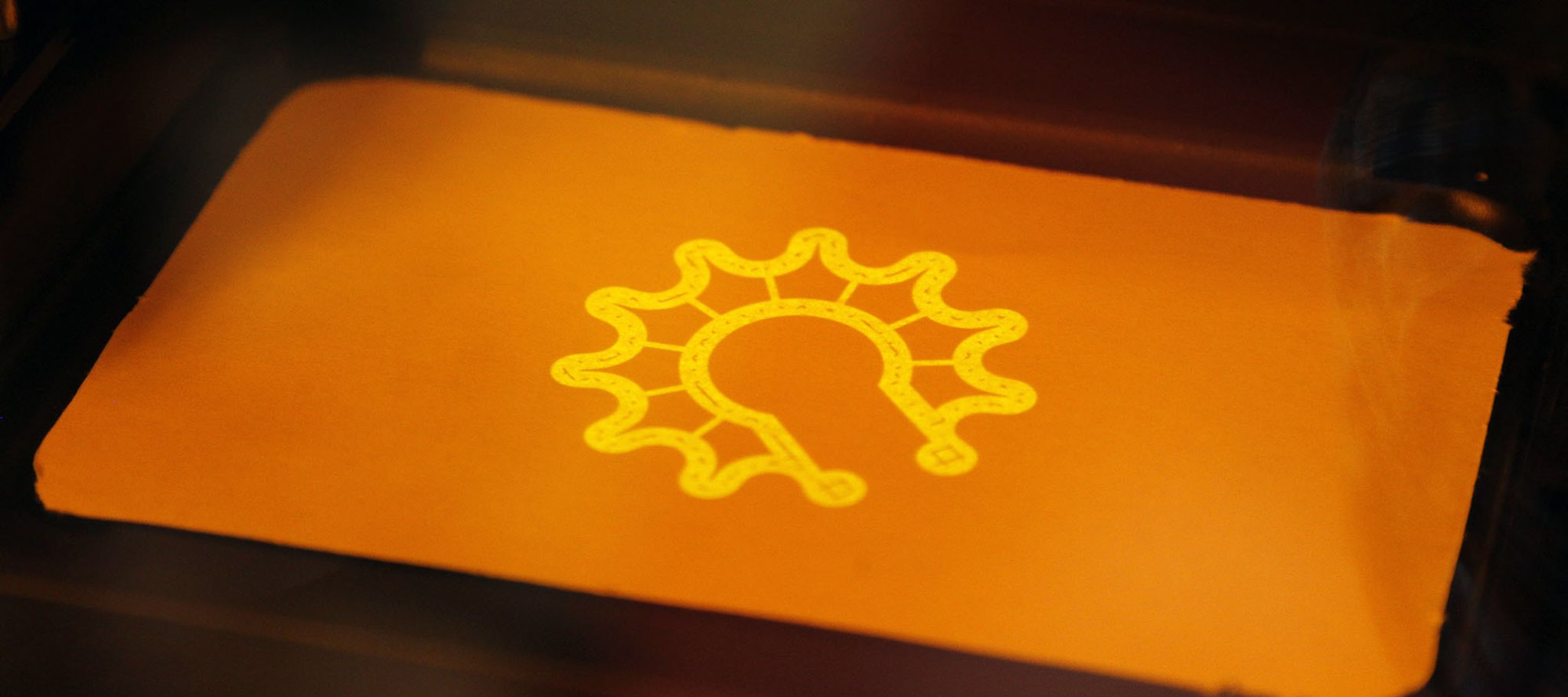 An ultraviolet laser is projected to create a simulated shape layer in the University of Dayton Research Institute’s Additive Manufacturing Technology Development lab. TY GREENLEES / STAFF