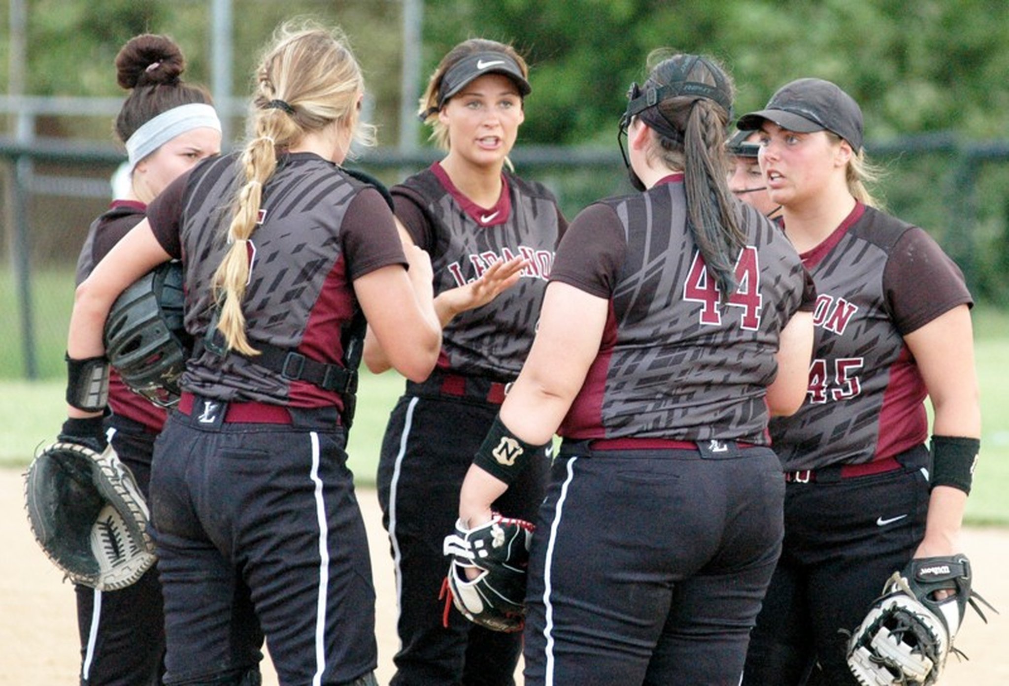 Lebanon’s Ashley West and Ashleigh Riffle (45) lead the conversation with pitcher Megan Deem (44) during a break in the action May 17 in a Division I district softball championship game against Lakota East at Centerville. East won 3-0. RICK CASSANO/STAFF