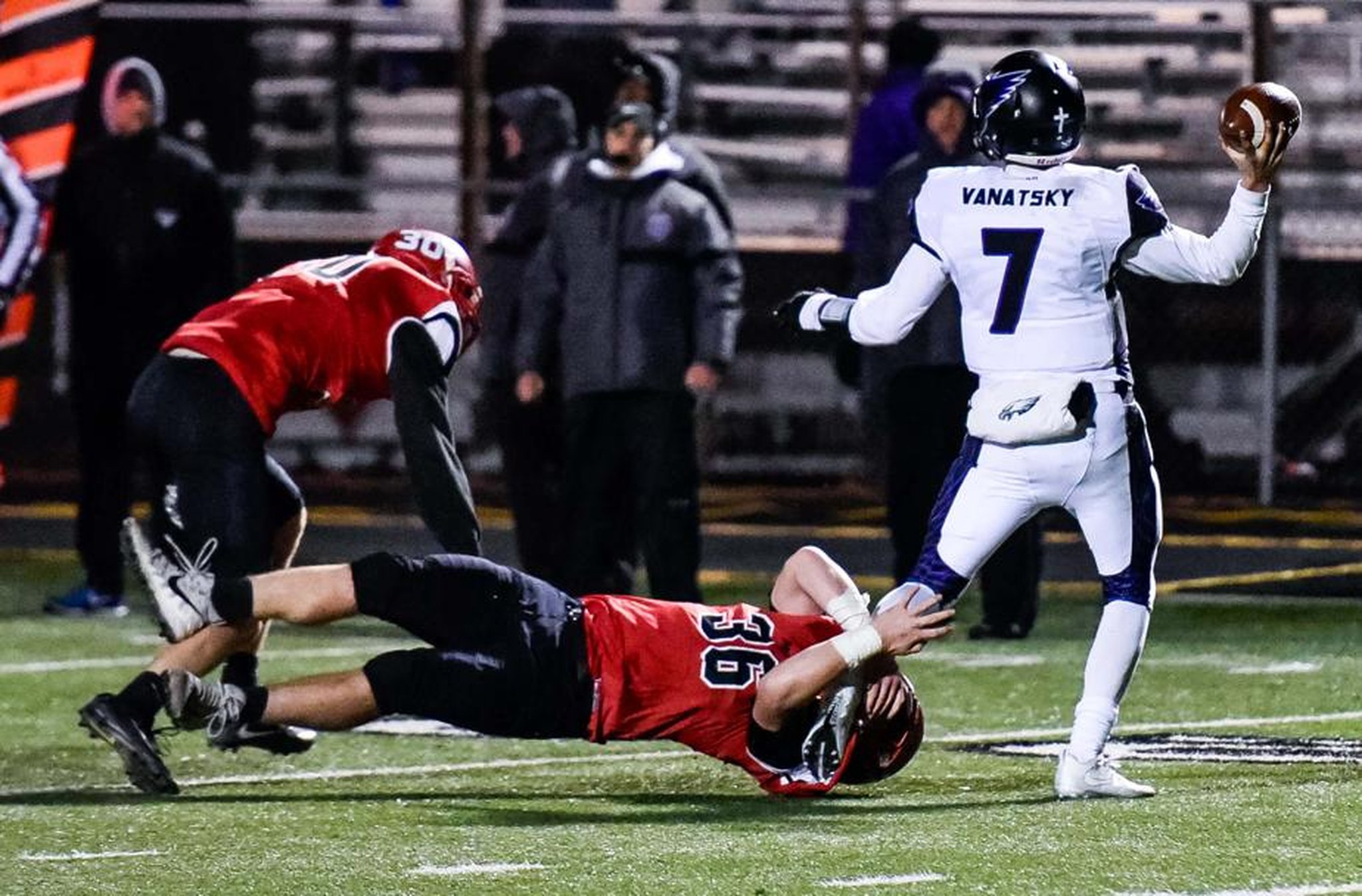 Madison’s Cole Pelgen (36) and Levi McMonigle (30) go after Cincinnati Hills Christian Academy quarterback Danny Vanatsky during a Division V, Region 20 semifinal at Lakota East on Nov. 10. NICK GRAHAM/STAFF