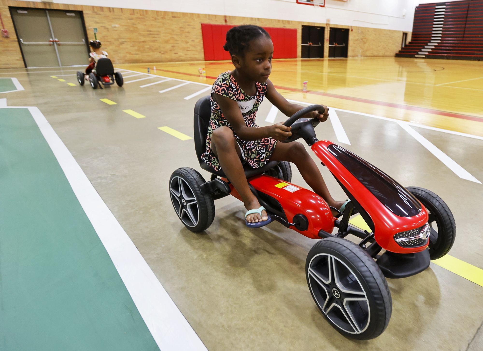 Haven Sweemer, 5, drives a pedal car during Lakota Safety Village. Lakota schools, West Chester Police Department, Butler County Sheriff's Office and other have partnered for Lakota Safety Village to teach young children going into kindergarten school etiquette, bus and car safety, fire safety and more at Lakota Freshman School in West Chester Township. NICK GRAHAM/STAFF