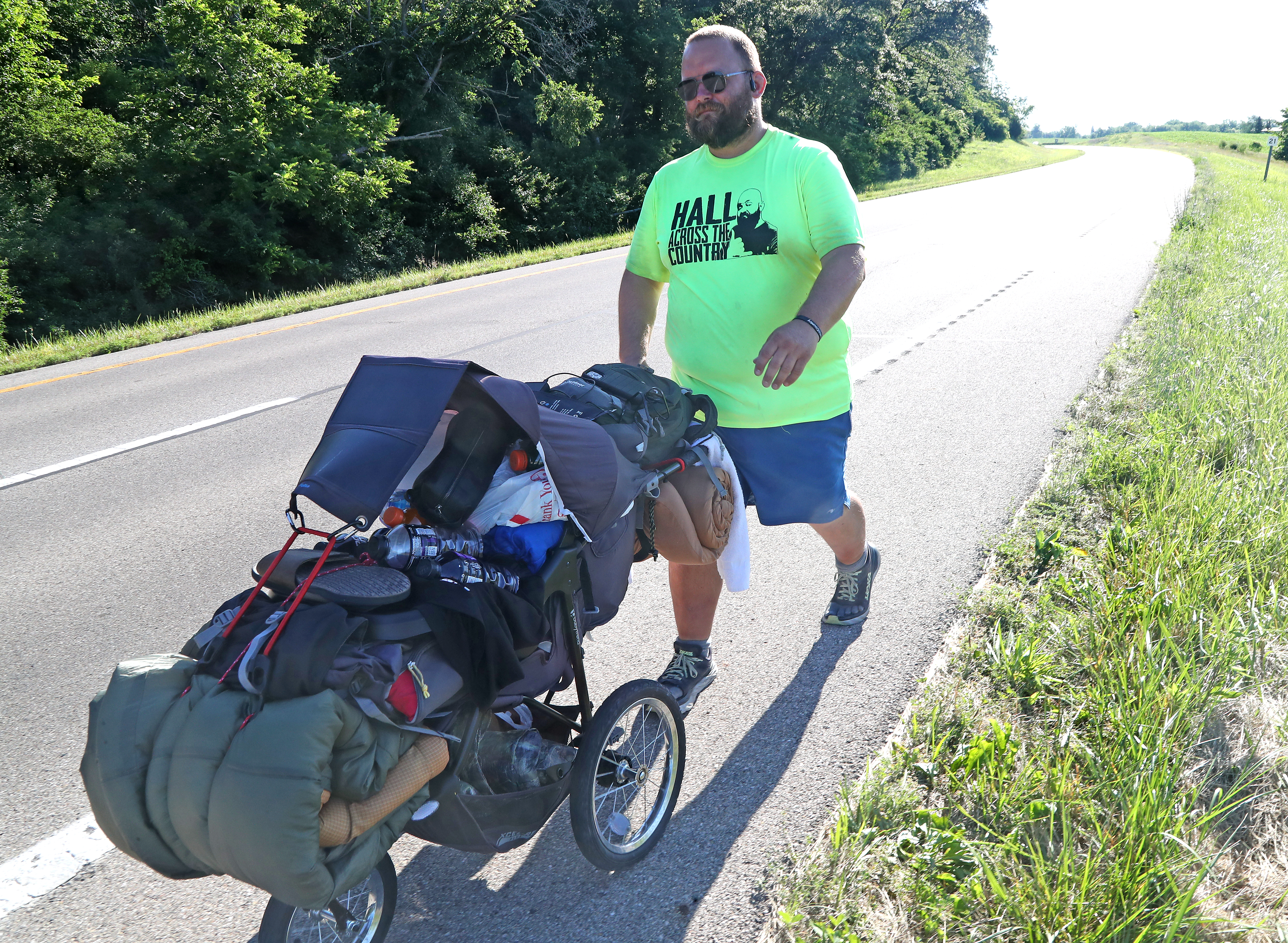 Joe Hall walks along US 40 between South Vienna and Springfield on Thursday, June 23, 2022. Hall is walking across America as part of a fundraiser for the Dayton Children's Behavioral Health Unit .  BILL LACKEY/STAFF