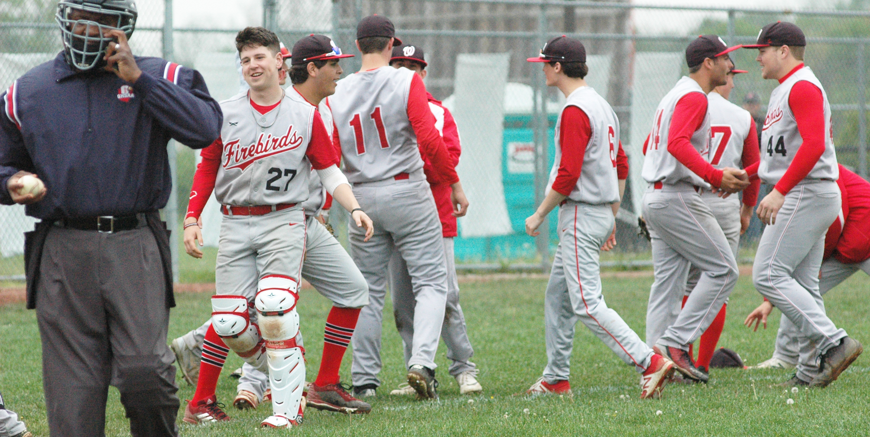 Lakota West’s players celebrate Saturday afternoon after a 5-3, nine-inning Greater Miami Conference baseball victory at Lakota East. RICK CASSANO/STAFF