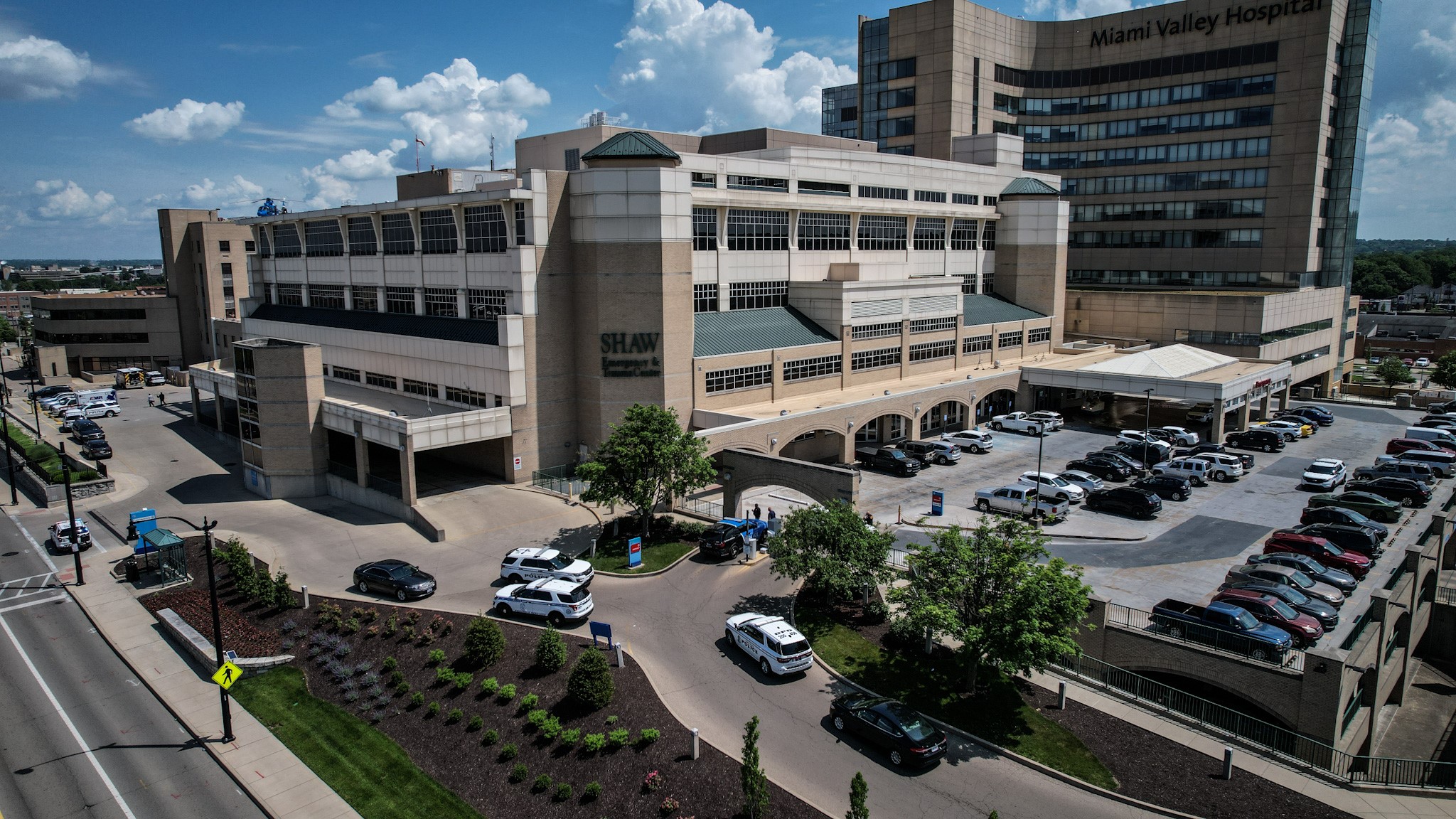 Police officers were outside Miami Valley Hospital Wednesday June 1, 2022, after a Montgomery County Jail inmate and a private security guard died in a shooting.  JIM NOELKER/STAFF