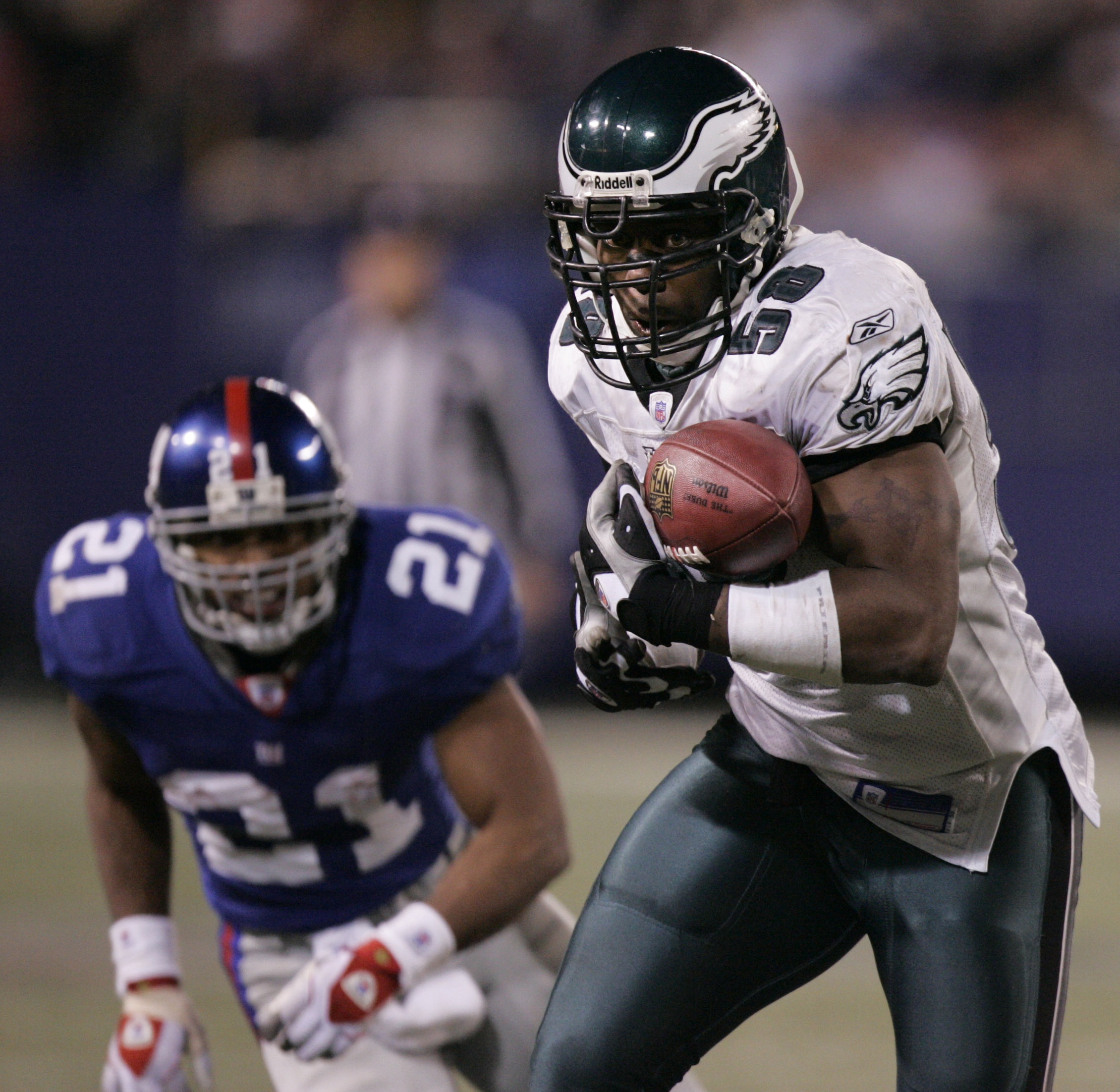 Philadelphia Eagles' Trent Cole, right, intercepts a pass by New York Giants' Eli Manning in front of Tiki Barber in the fourth quarter during NFL football action Sunday, Dec. 17, 2006 in East Rutherford, N.J. Cole ran the interception back for a touchdown sealing the Eagles' 36-22 win. (AP Photo/Julie Jacobson)