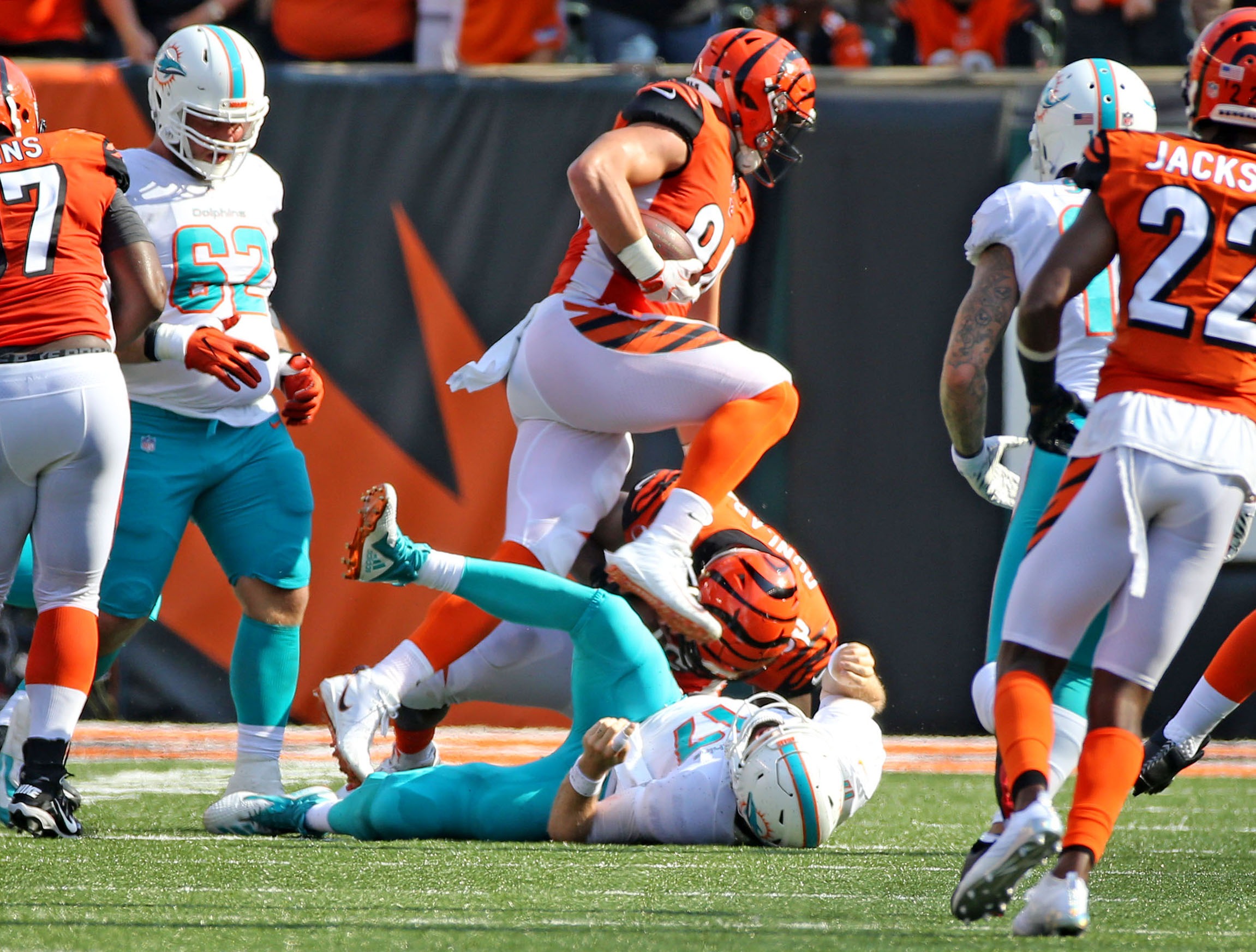 Miami Dolphins quarterback Ryan Tannehill lays on the field as Cincinnati Bengals’ Sam Hubbard ran for a touchdown after recovering a fumble during the fourth quarter at Paul Brown Stadium in Cincinnati, Ohio, Oct. 7, 2018. The Dolphins fell to the Bengals 27-17. (Charles Trainor Jr./Miami Herald/TNS)
