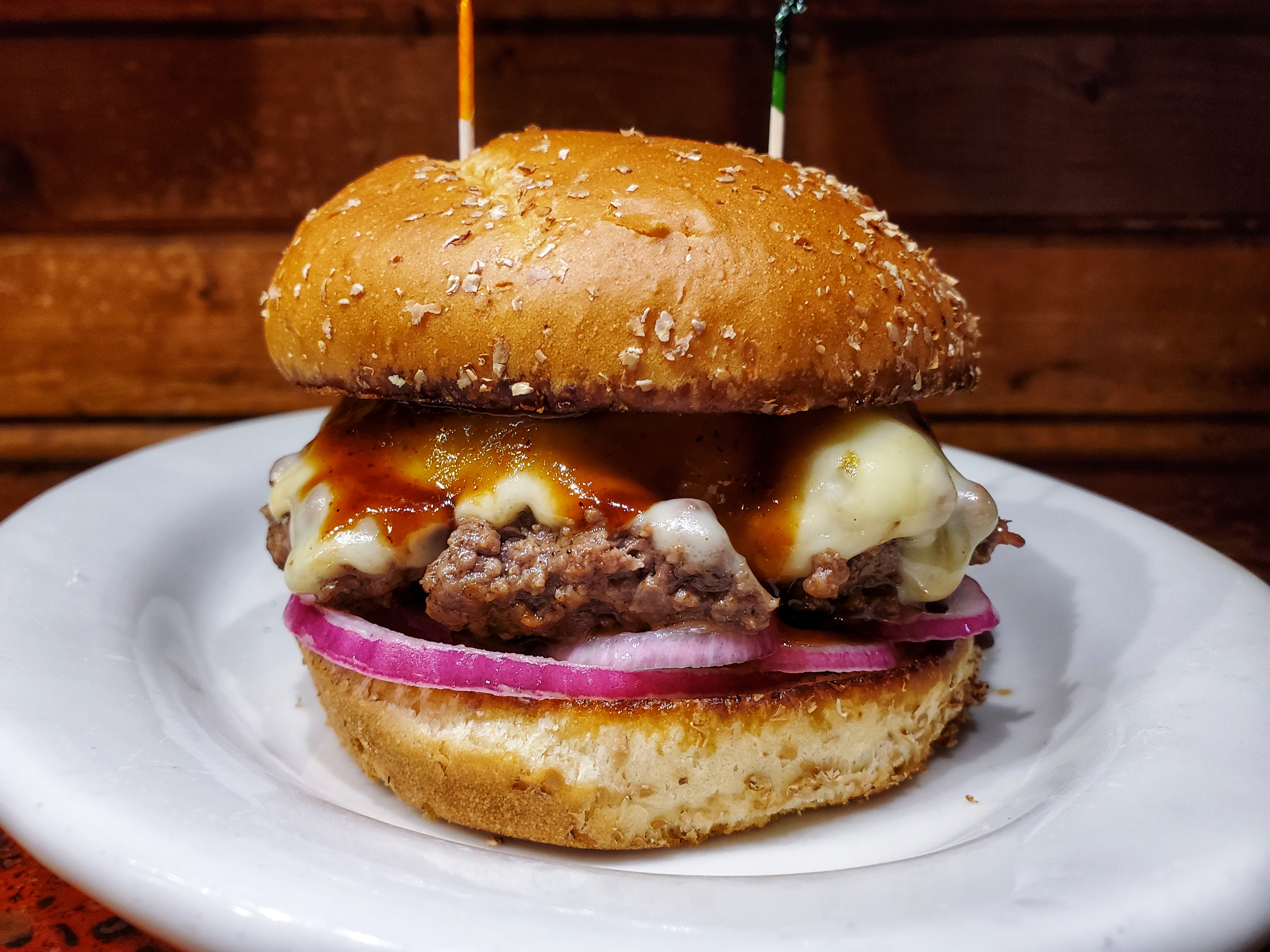 Nick's Restaurant: a 7oz. Hand spanked beef patty cooked to perfection with pickled red onion, pepper-jack cheese, and topped with house made horseradish bbq sauce.