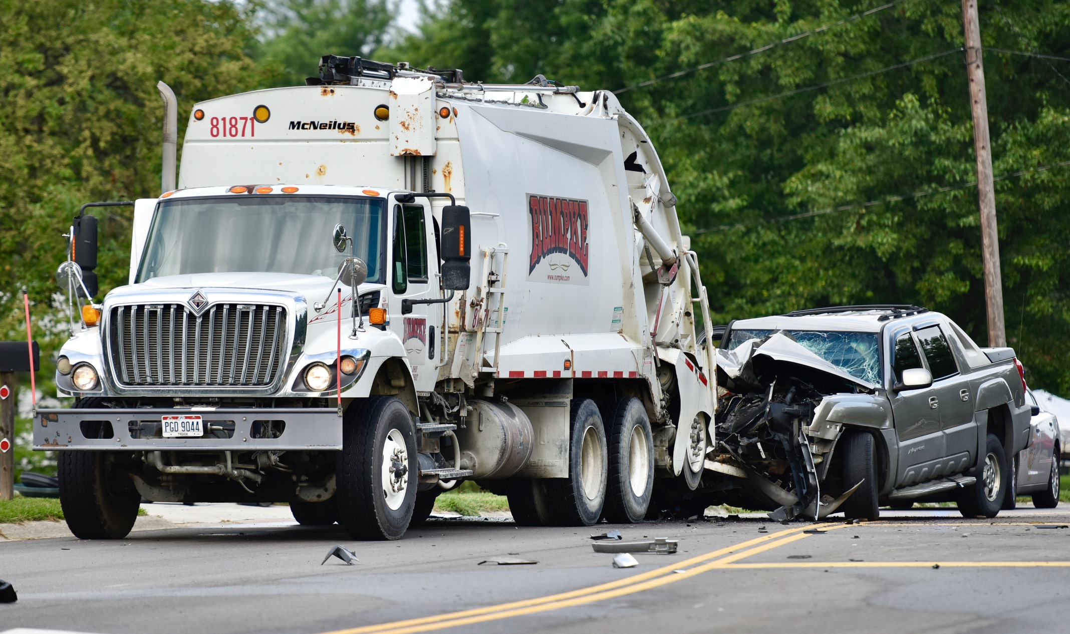 A Rumpke employee was pinned between the back of a trash truck and a pickup truck in a crash Monday morning in Middletown.