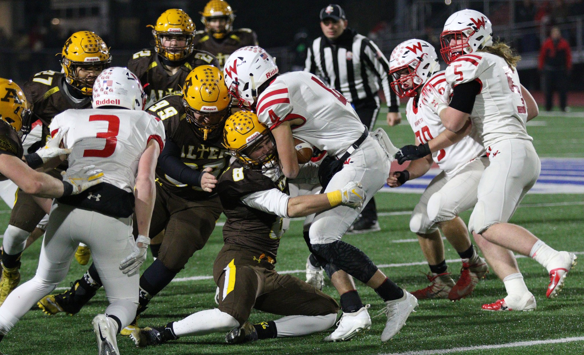 Alter’s Matthew Schimpf tackles Wapakoneta’s Riley Gibson during the Knights’ 21-7 victory over Wapakoneta in the Division III, Region 12 high school football championship at Piqua High School’s Alexander Stadium on Friday, Nov. 16, 2018. MICHAEL COOPER / CONTRIBUTED