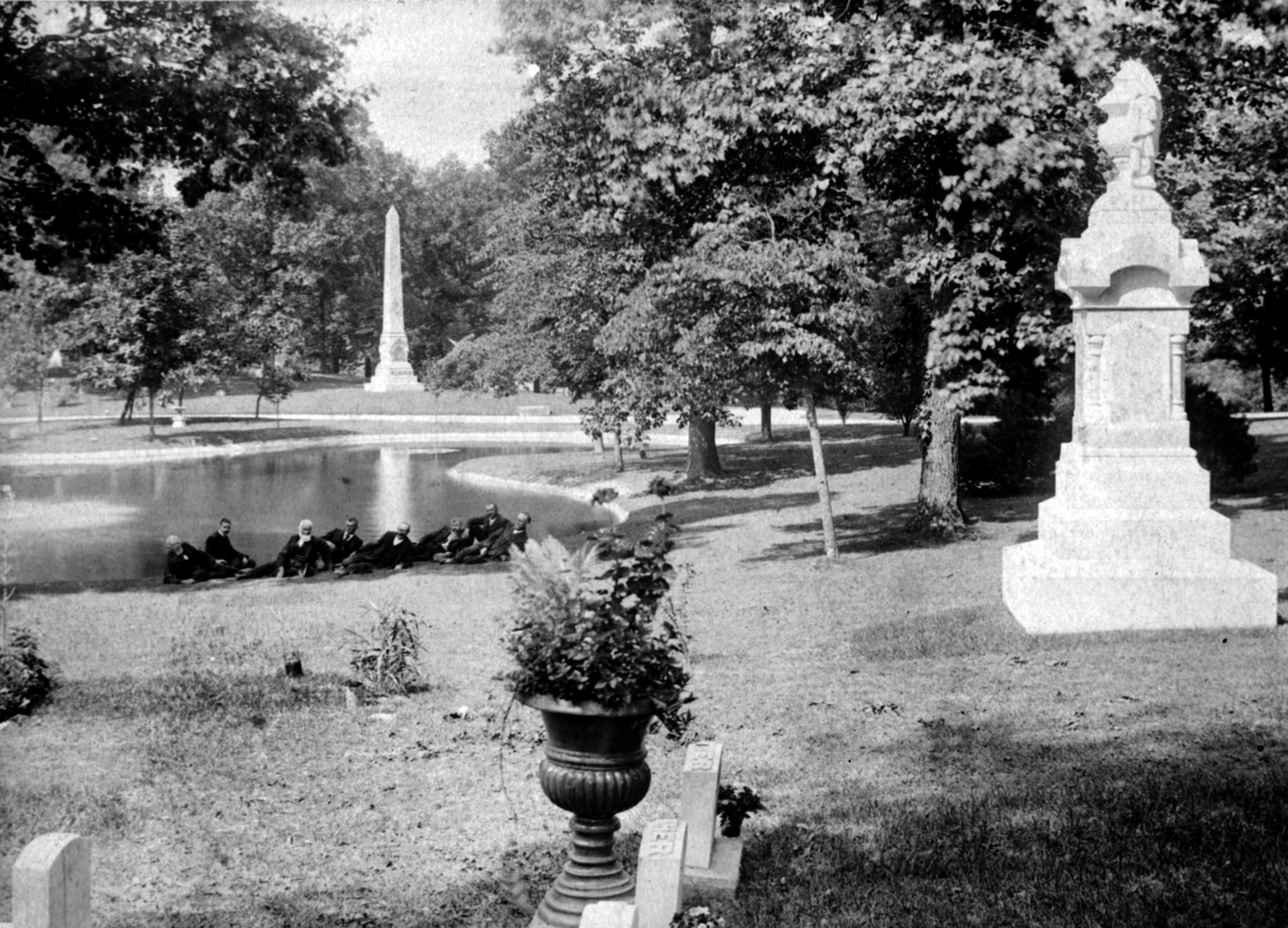 A group of men lounge at the edge of a lake at Woodland Cemetery. Woodland Cemetery and Arboretum is one of the nation's oldest garden cemeteries. WRIGHT STATE UNIVERSITY ARCHIVES