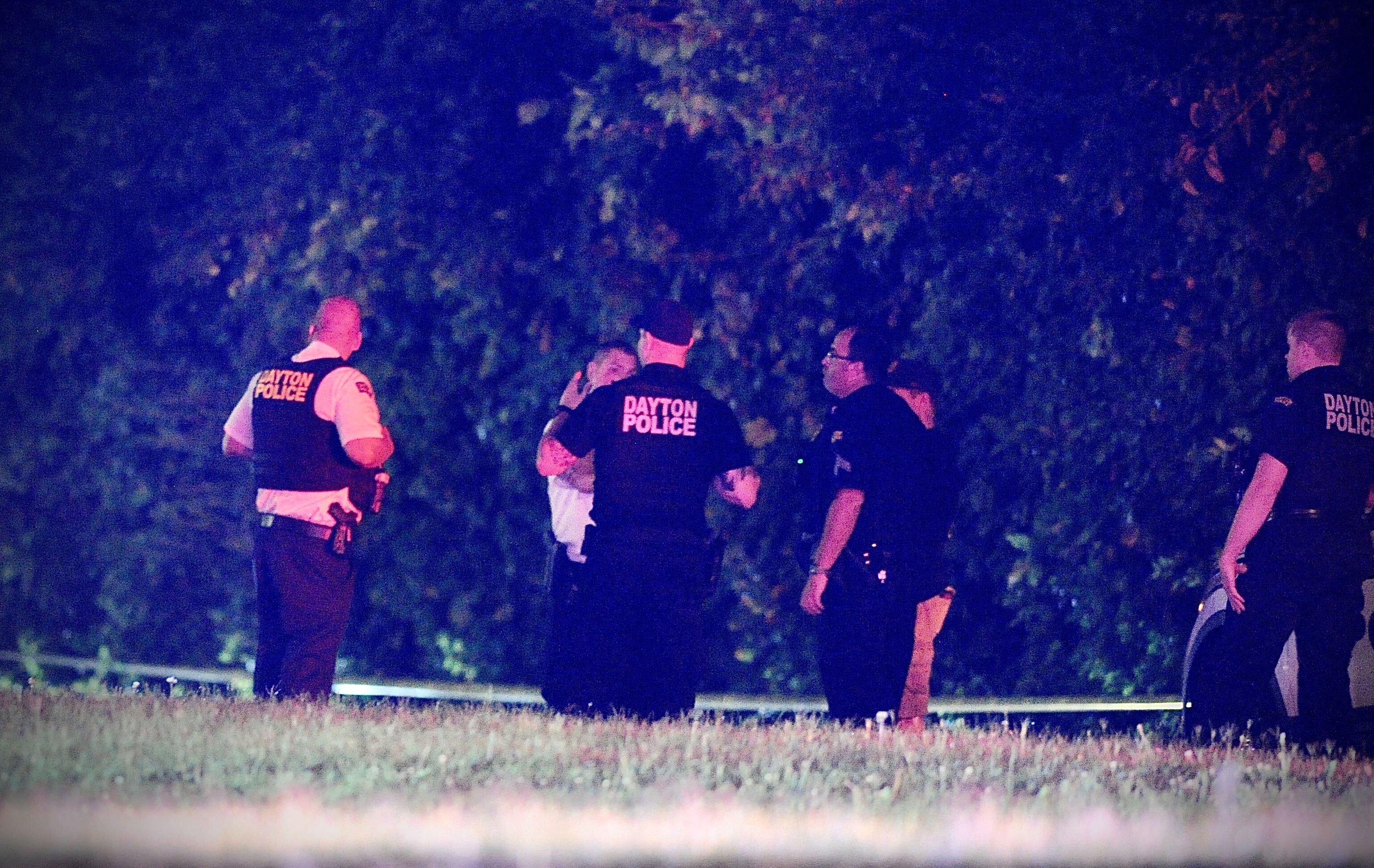 Police work at a scene on Ingram Street where a Dayton police officer and a suspect were shot. MARSHALL GORBY \STAFF