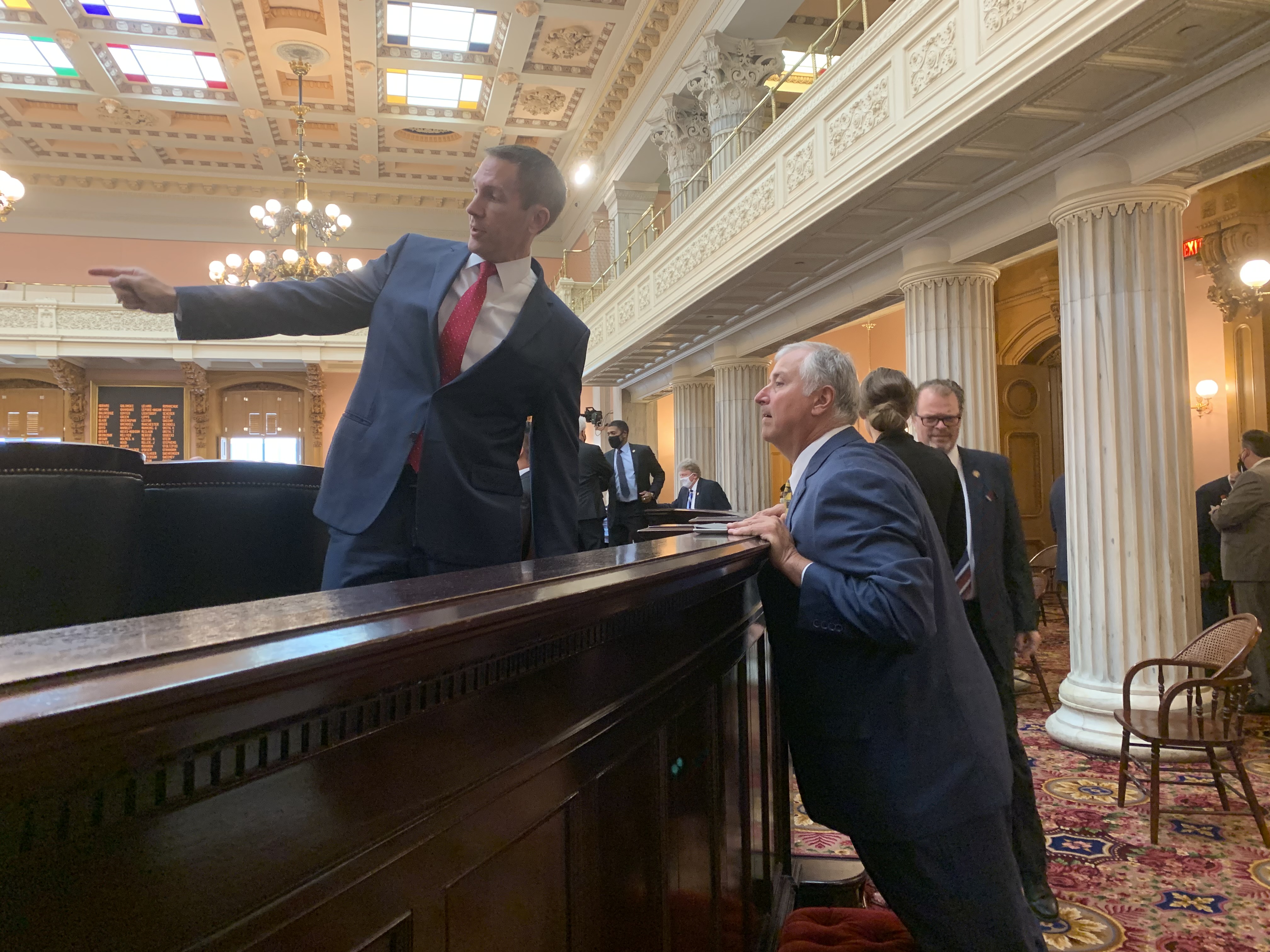 State Rep. Jim Butler, R-Oakwood, directs former Ohio House speaker Larry Householder, R-Glenford, to his new seating assignment. Under indictment in a public corruption case, Householder attended session.