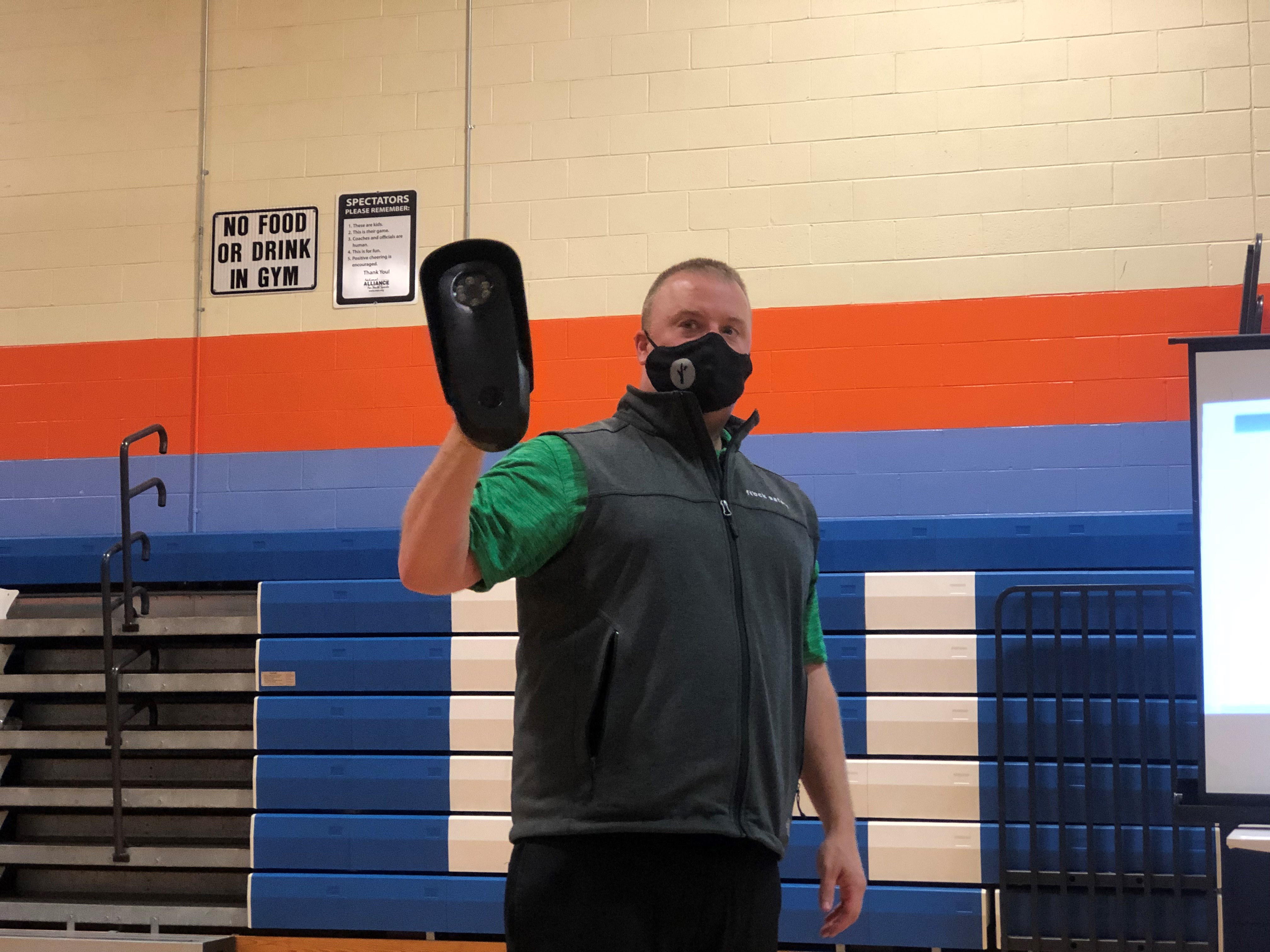 Flock Safety Territory Manager Rick Lombardo holds an automated license plate reader at a community meeting. The Dayton Police Department says it is considering deploying the devices in neighborhoods that want them. CORNELIUS FROLIK / STAFF