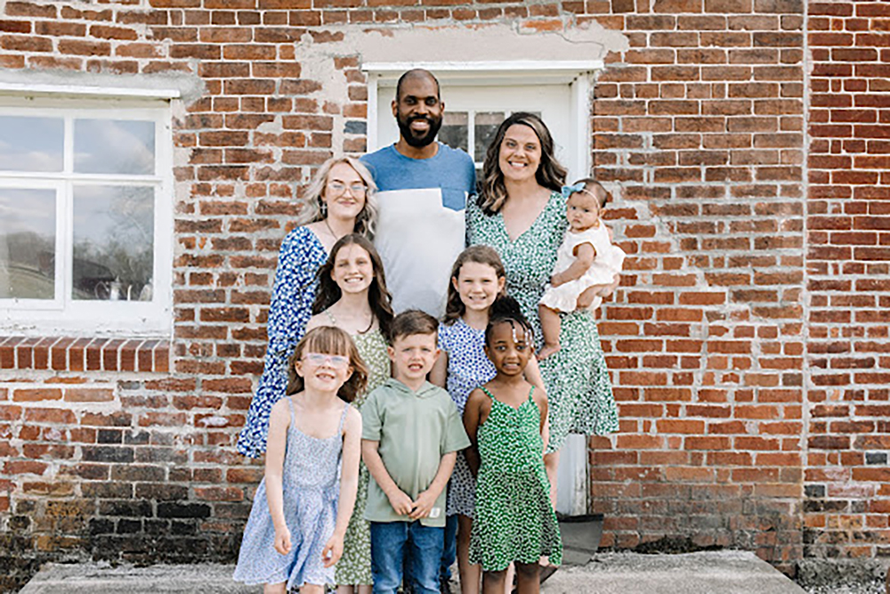 The Ivery family includes six adopted children. Their youngest daughter, Hanaley, was born to Megan (R - holding Hanaley) 9 months ago after the couple adopted a frozen embryo. L-R (back row) Zoie, Shimar, Megan and Hanaley, (middle row) Sophia, Lia (front row) Makenzie, Braxton and Janiyah (not adopted but considered part of the family!)