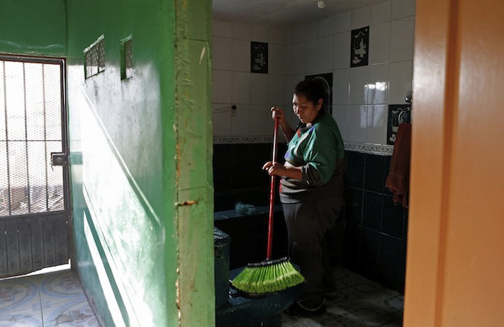 Berta Lopez cleans her home on her day off. For the last couple of years, every spare peso has gone to pay the college tuition for her youngest son. (Katie Falkenberg/Los Angeles Times/TNS)
