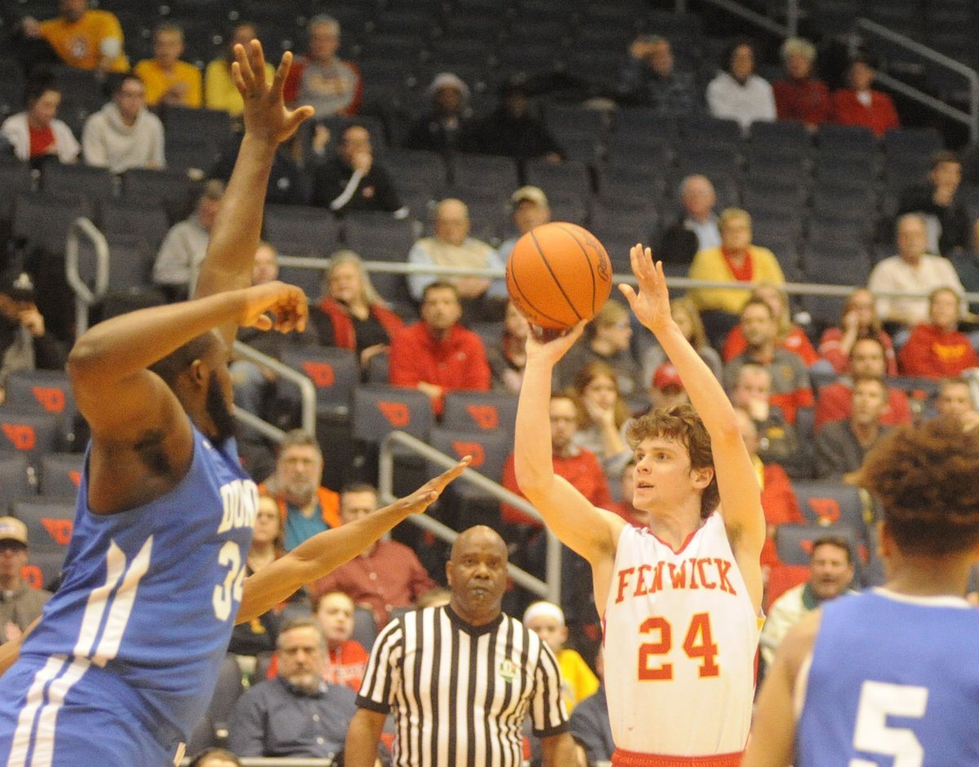 Fenwick’s David Luers (24) takes a shot over Dunbar’s Jonathan Allen (34) on Wednesday night during a Division II sectional final at the University of Dayton Arena. MARC PENDLETON/STAFF