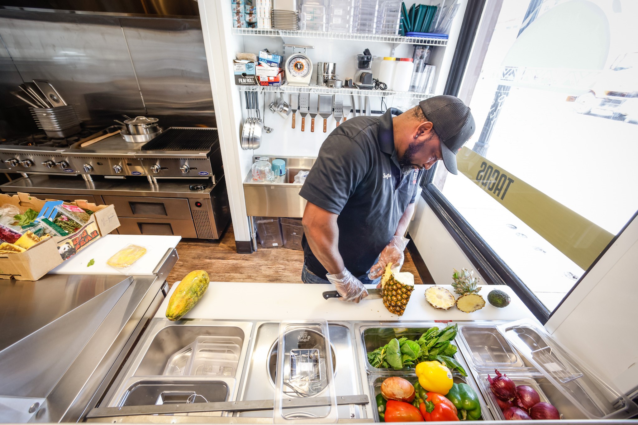 SOCA owner, Shafton Greene readies his kitchen at West Social Tap and Table, located at 1100 West Third St. in Dayton. The food hall plans to open July 25, 2022 and features six local restaurants. JIM NOELKER/STAFF