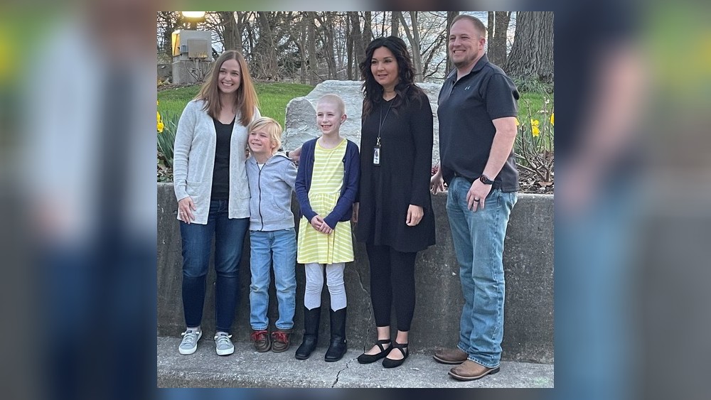 Chloe Adkins (center) became the youngest recipient ever of the Kettering mayor’s volunteer award after continuing to freely offer her services while battling cancer. Surrounding her, from left to right, are Kettering City Schools gifted intervention specialist, Karen Kronour, Chloe's brother Jake, and their parents, Kelly and Jeff Adkins. CONTRIBUTED