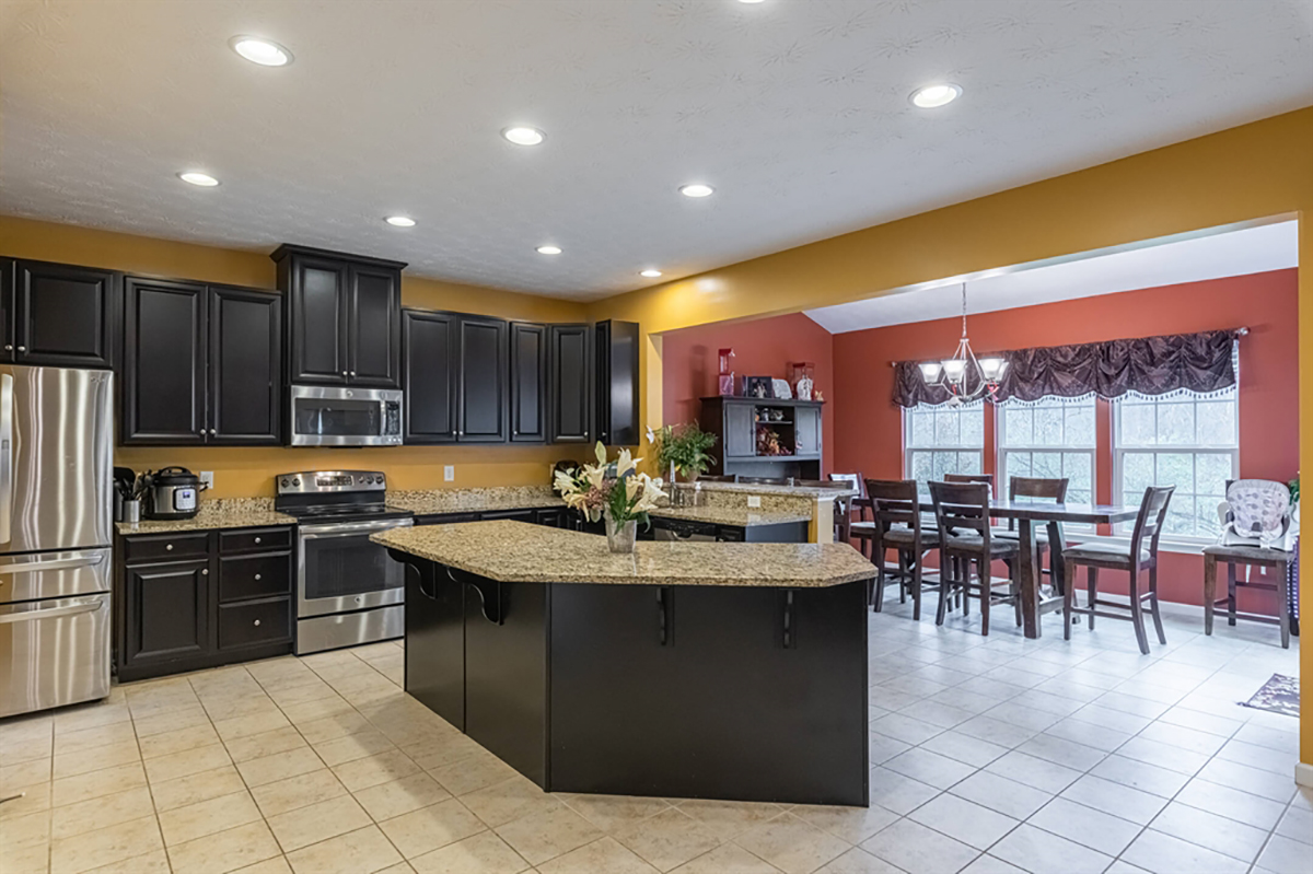 The kitchen has dark 42-inch cabinetry that fills one wall and wraps around along a peninsula counter that divides the kitchen from the morning room. Light granite countertops complement the cabinetry, which also includes an angled island with breakfast bar seating and storage.
CONTRIBUTED PHOTO