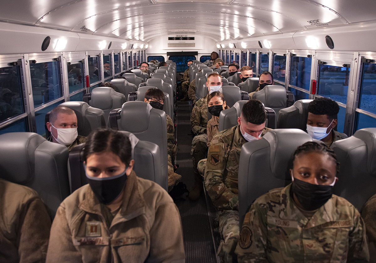 Airmen from the 88th Medical Group wait on a bus outside Wright-Patterson Medical Center on March 19 as they deploy to Detroit in support of the Federal Emergency Management Agency’s COVID-19 response. According to the Federal Emergency Management Agency, military and support personnel throughout the country have already administered about 700,000 vaccines, and a single Type 1 team is capable of delivering 6,000. U.S. AIR FORCE PHOTO/WESLEY FARNSWORTH