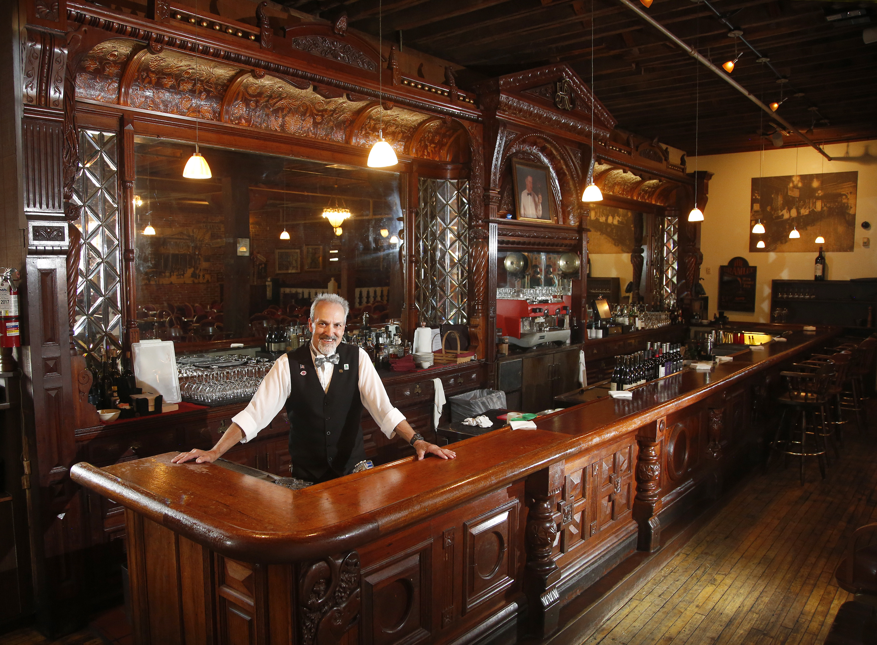 Bob Moats has worked behind the historic bar at Jay's Restaurant in Dayton for 33 years. The bar was originally hand carved for the Pony House Restaurant in 1882. LISA POWELL / STAFF