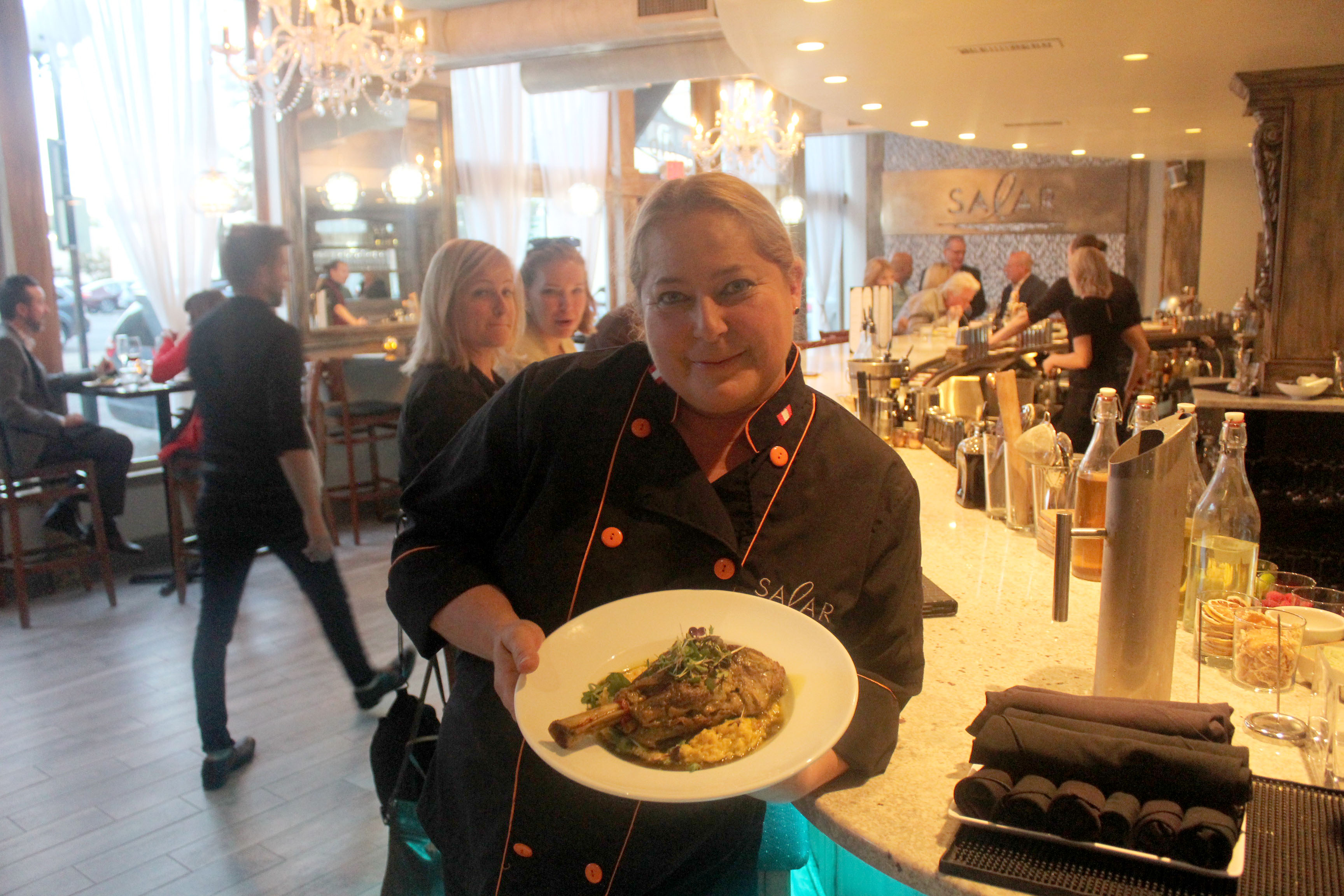 Salar Restaurant and Lounge has been closed since a December fire. The restaurant in Dayton Oregon District is celebrating its reopening with event Sept 27 to 30, 2018. Chef/owner Margot Blondet holds a serving of Northern Peruvian style braised lamb shank is pictured.