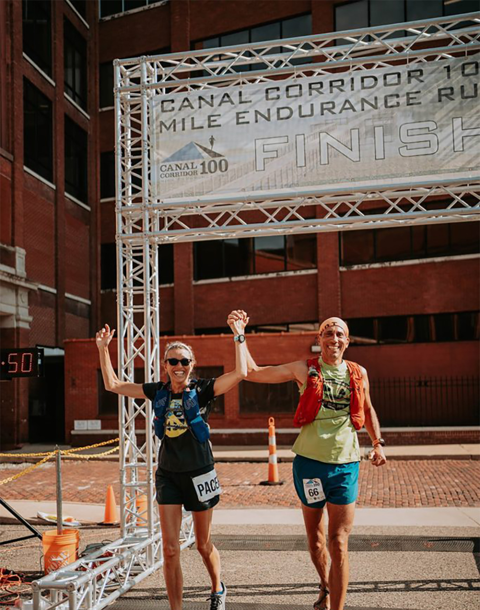 Randy Kreill changed his lifestyle dramatically after his cancer diagnosis. That included long distance runs, which he does in minimalist shoes. He is crossing the finish line at the Canal Corridor 100 Mile Race in July 2020 with his wife Megan.