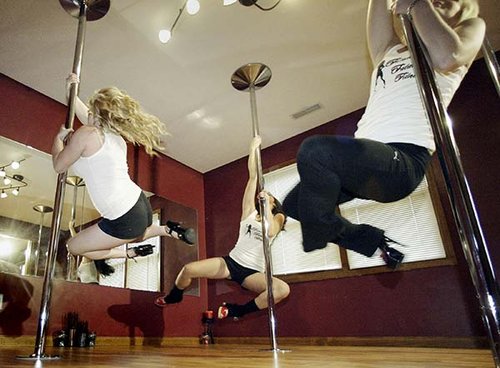 From left, Jacqueline Allen and sisters, Mandy and Jenny Barnes pole dance at Femme Fatale Fitness.