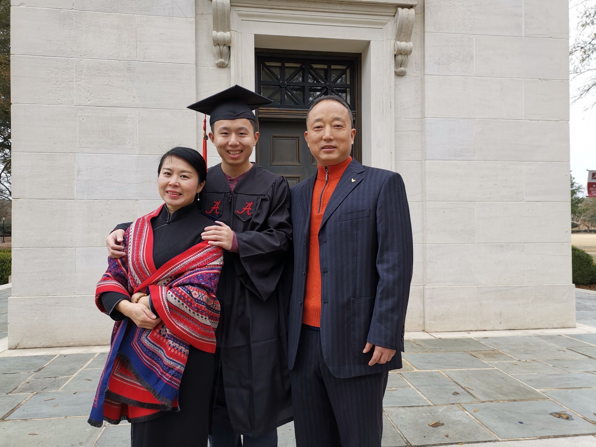 Hyde (QiYun) Li with his mother, XiaoPing, and his father, JianHua, at his graduation from the University of Alabama.  CONTRIBUTED