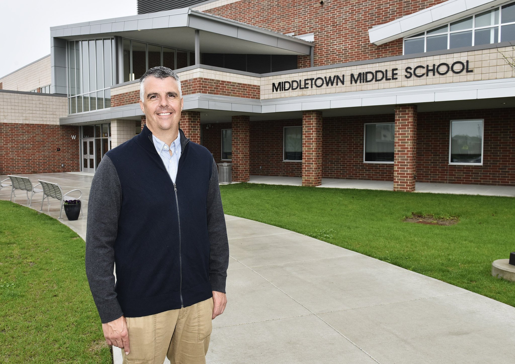 Chris Urso, president of the Middletown Board of Education, stands in front of the new Middletown Middle School, which was built with the help of state funding through the Ohio Facilities Construction Commission (OFCC). Middletown is one of a dozen local school districts helped by the OFCC but the state agency is experiencing a funding slowdown that will delay projects in Franklin and Monroe Schools.