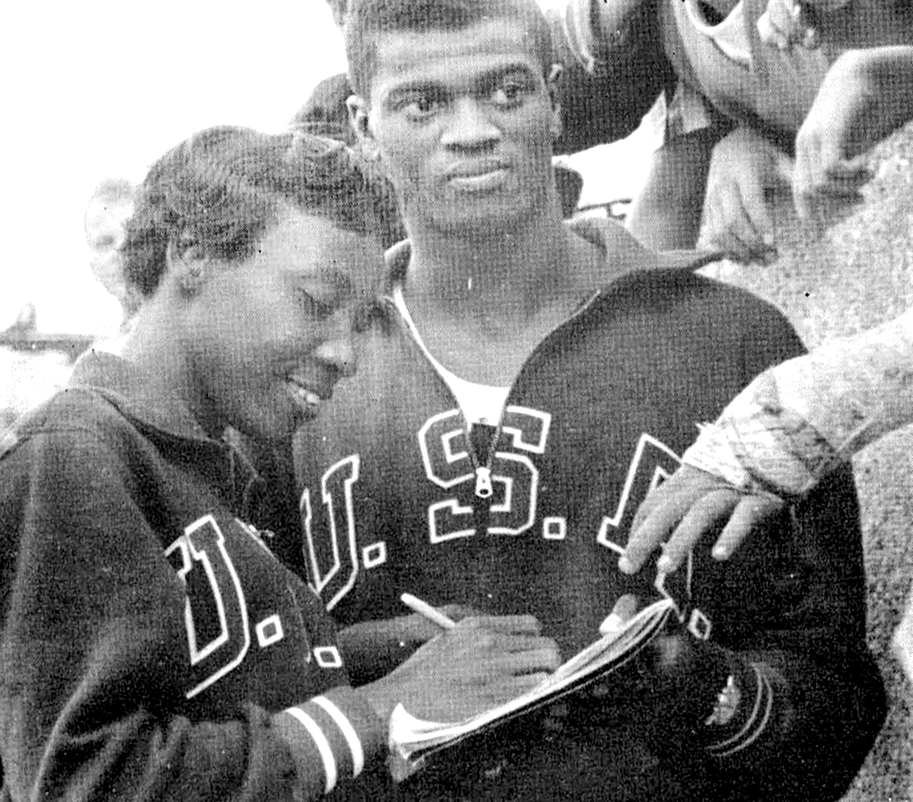 Lucinda Williams signs an autograph during the 1960 Rome Olympics. At right is fellow Olympian Ray Norton. Photo courtesy of Tennessee State University.