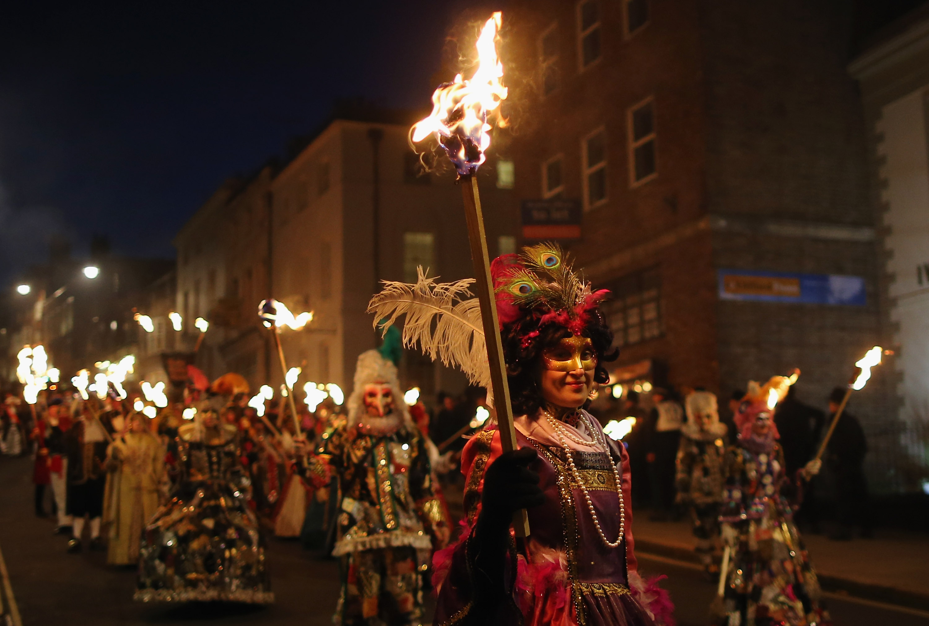 LEWES, ENGLAND - NOVEMBER 05: Members of the Pheonix Bonfre society walk with burning staffs during the Bonfire Night celebrations on November 5, 2012 in Lewes, Sussex in England. Bonfire Night is related to the ancient festival of Samhain, the Celtic New Year. Processions held across the South of England culminate in Lewes on November 5, commemorating the memory of the seventeen Protestant martyrs. Thousands of people attend the parade as Bonfire Societies parade through the narrow streets until the evening comes to an end with the burning of an effigy, or 'guy,' usually representing Guy Fawkes, who died in 1605 after an unsuccessful attempt to blow up The Houses of Parliament. (Photo by Dan Kitwood/Getty Images)