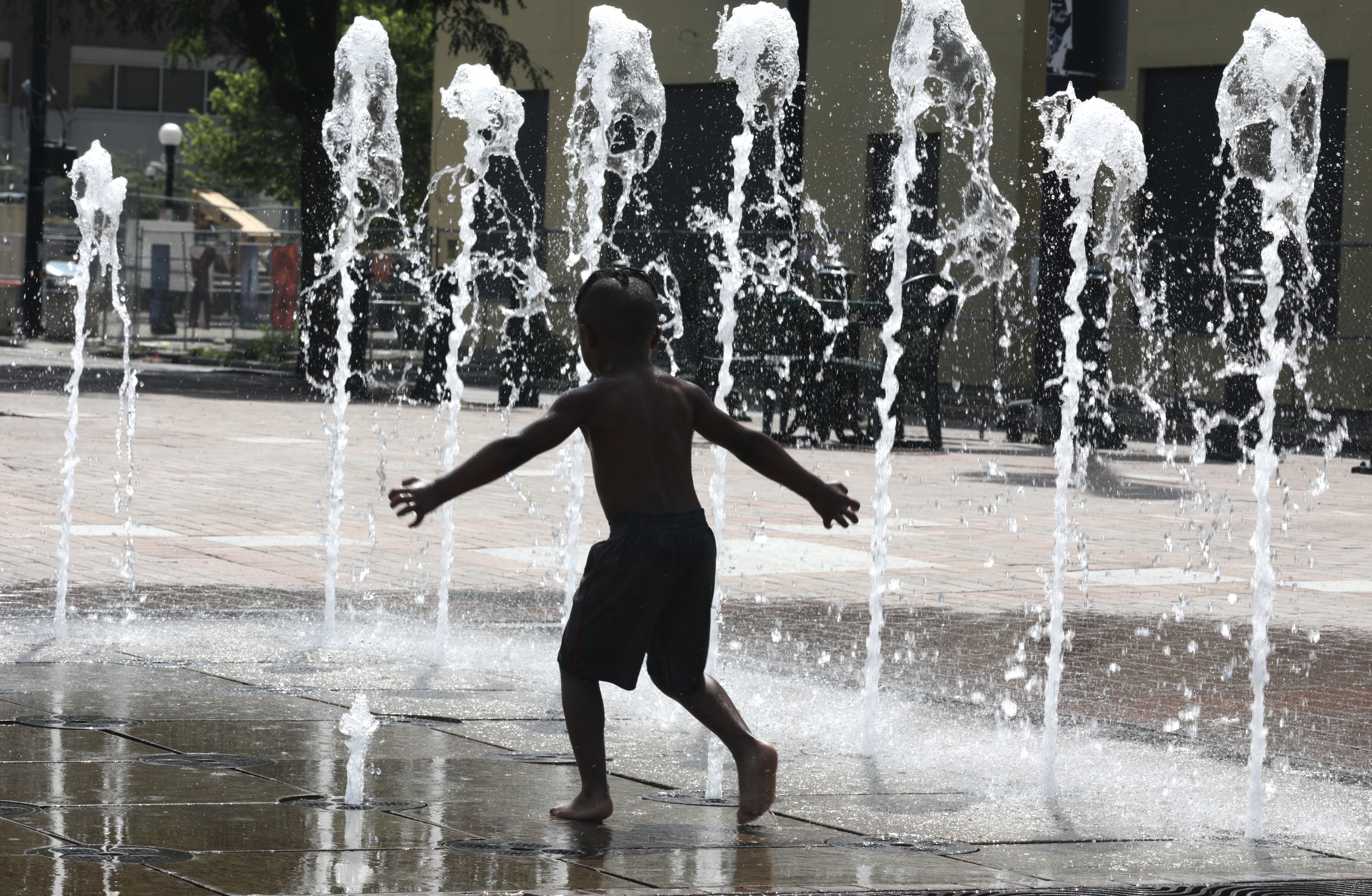 Ollie Arnold, 4, cools off in the interactive fountain at Van Cleve Park in downtown Dayton on Monday, June 13, 2022. BILL LACKEY/STAFF