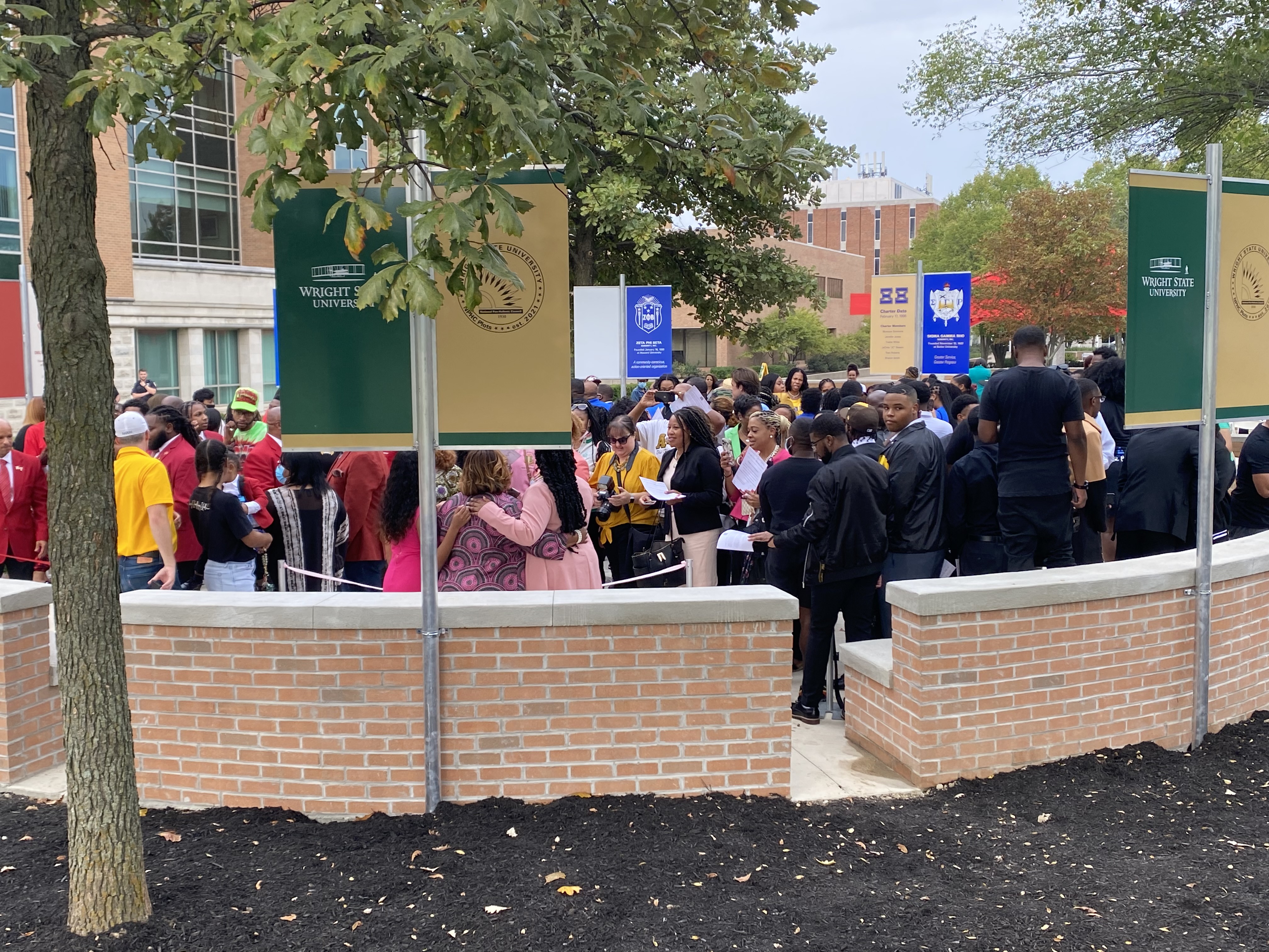 NPHC members walk into the National Pan-Hellenic Council Memorial Plots for the first time after the ribbon cutting on Saturday. Eileen McClory / Staff