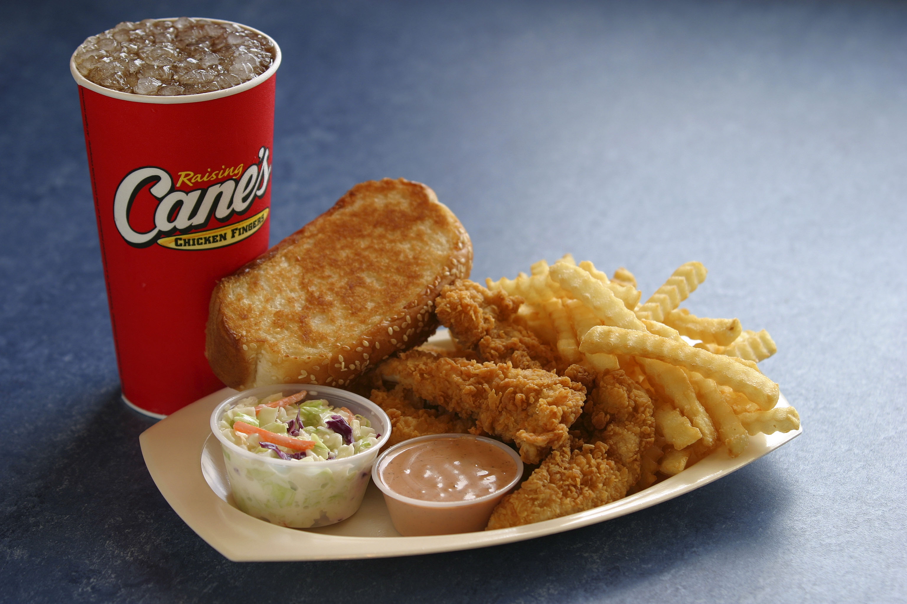 Raising Cane’s menu includes chicken fingers, crinkle-cut fries, cole slaw, Texas Toast and Cane s Sauce.