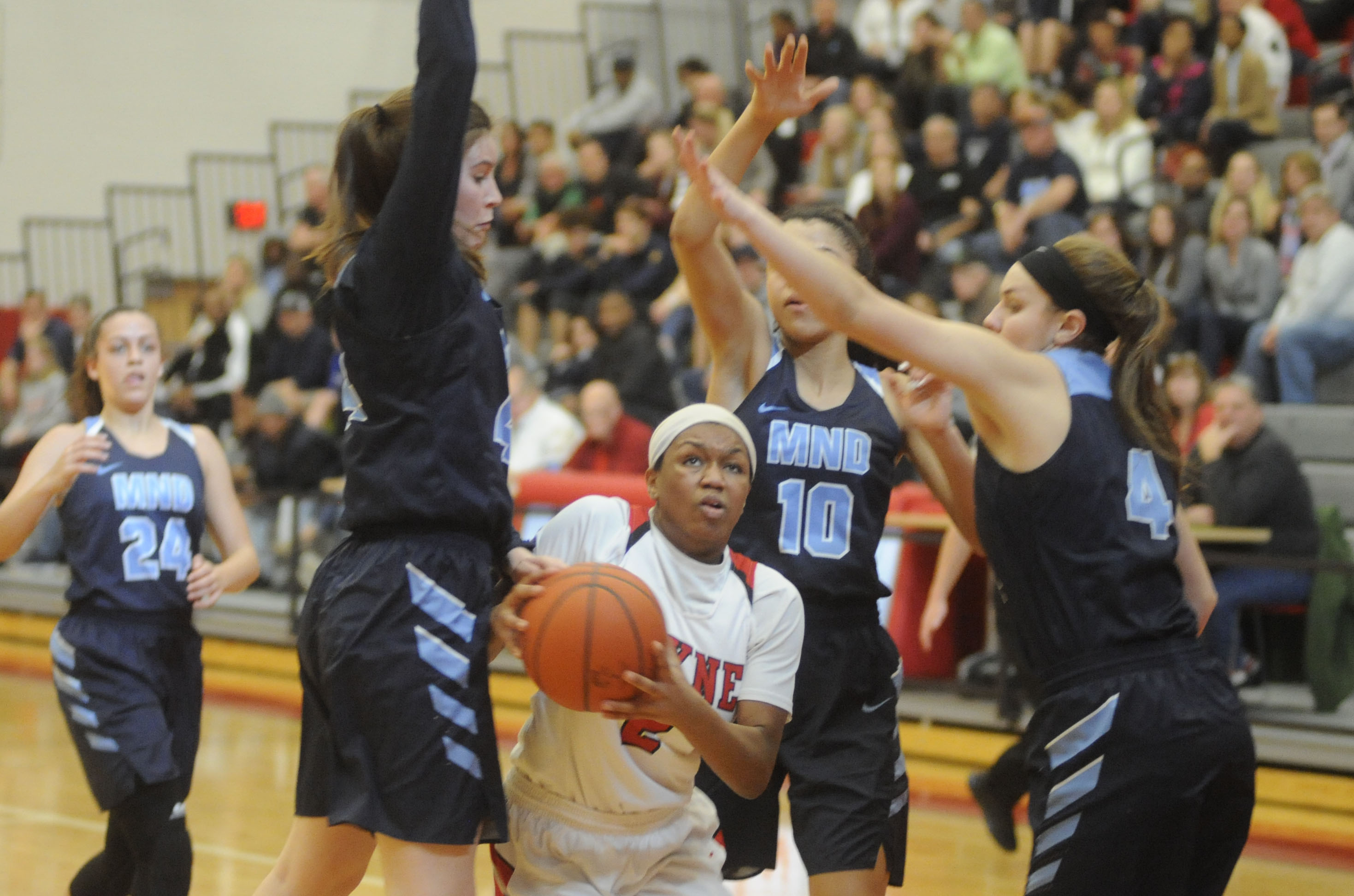 Nyla Hampton of Wayne (with ball) takes on three MND defenders. MARC PENDLETON / STAFF